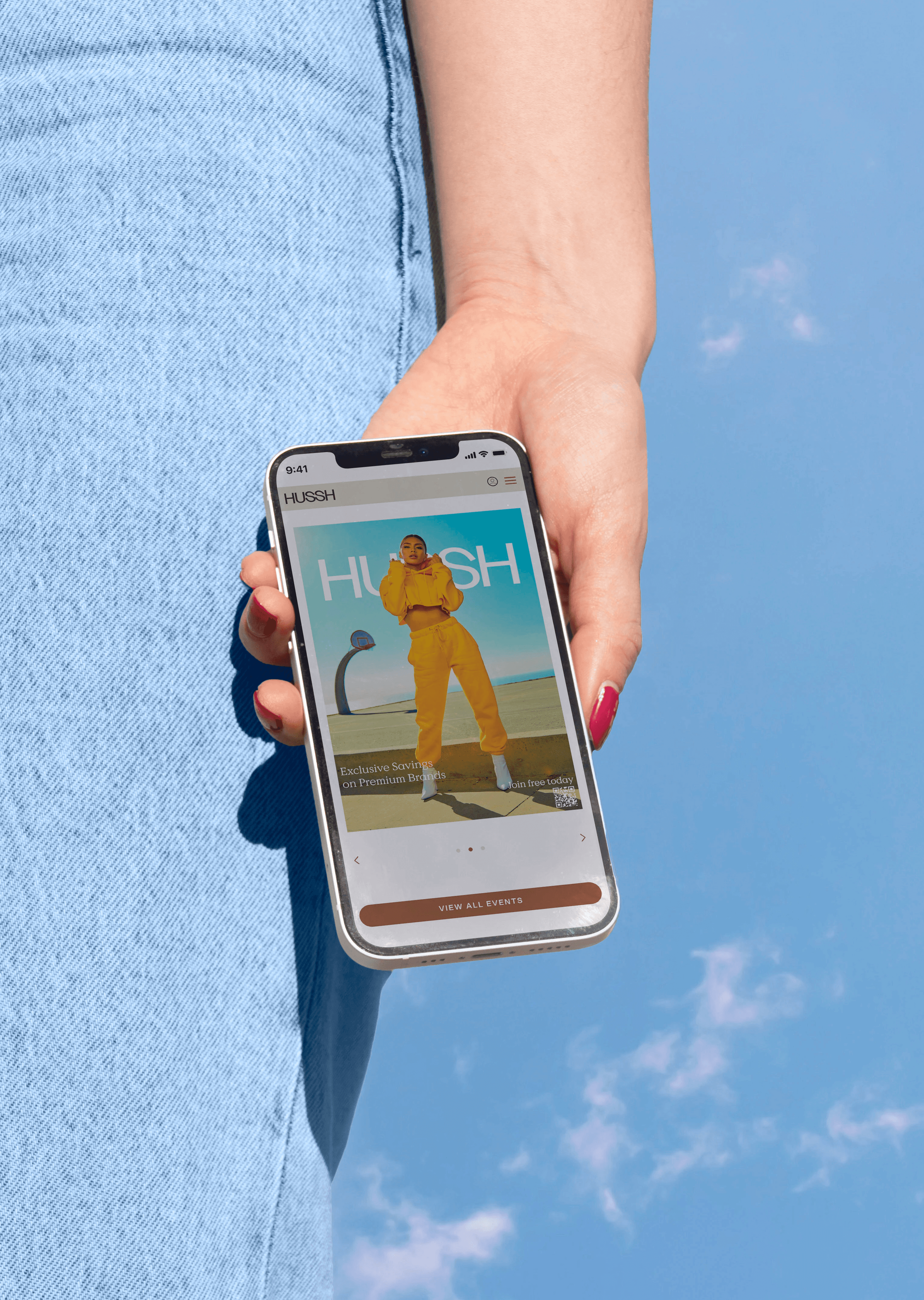 Phone in hand of woman in blue jeans