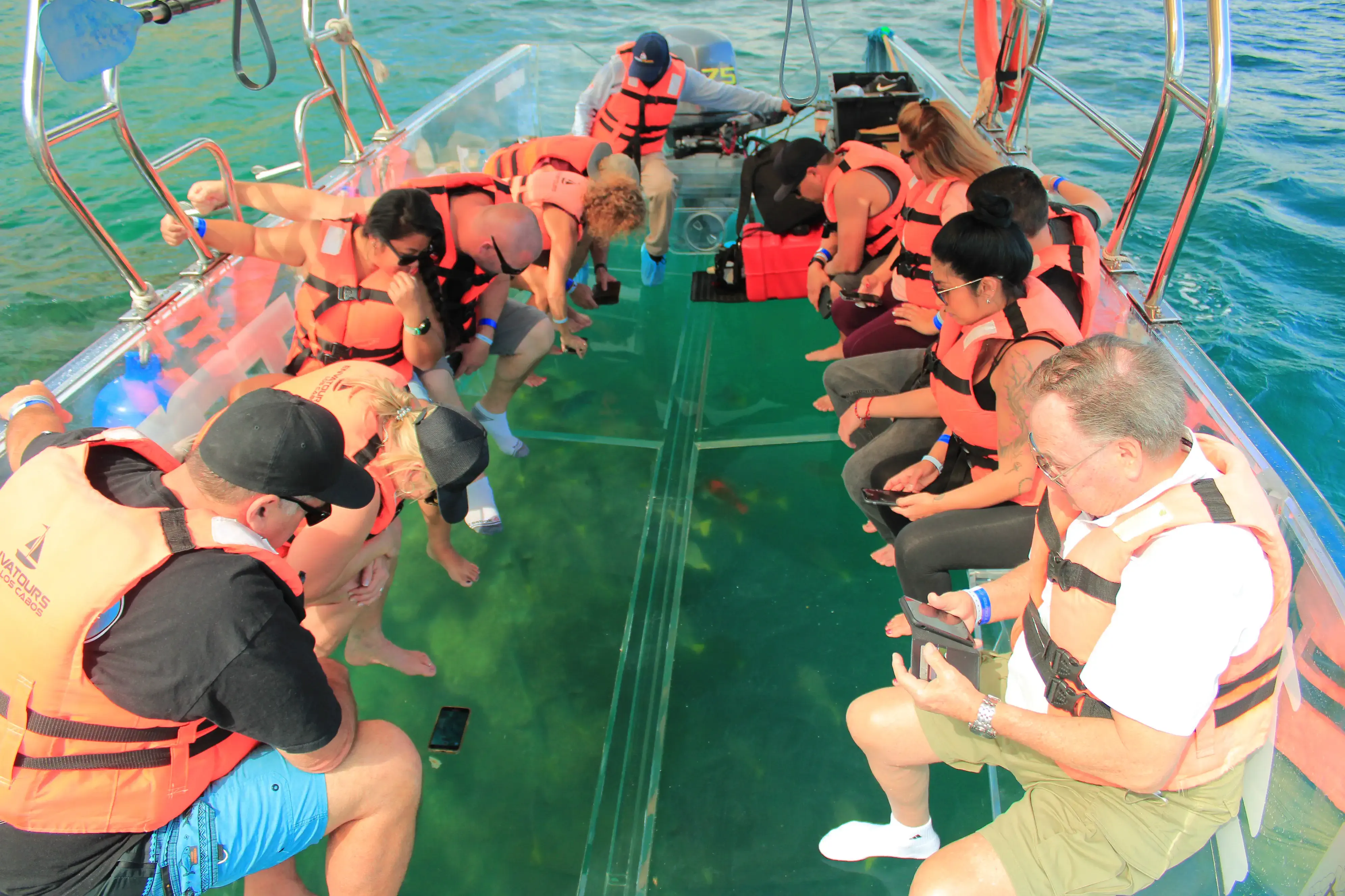 team on glass bottom boat tour in ocean
