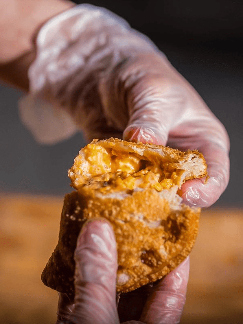 Close-up of an emapanda being pulled apart to show filling