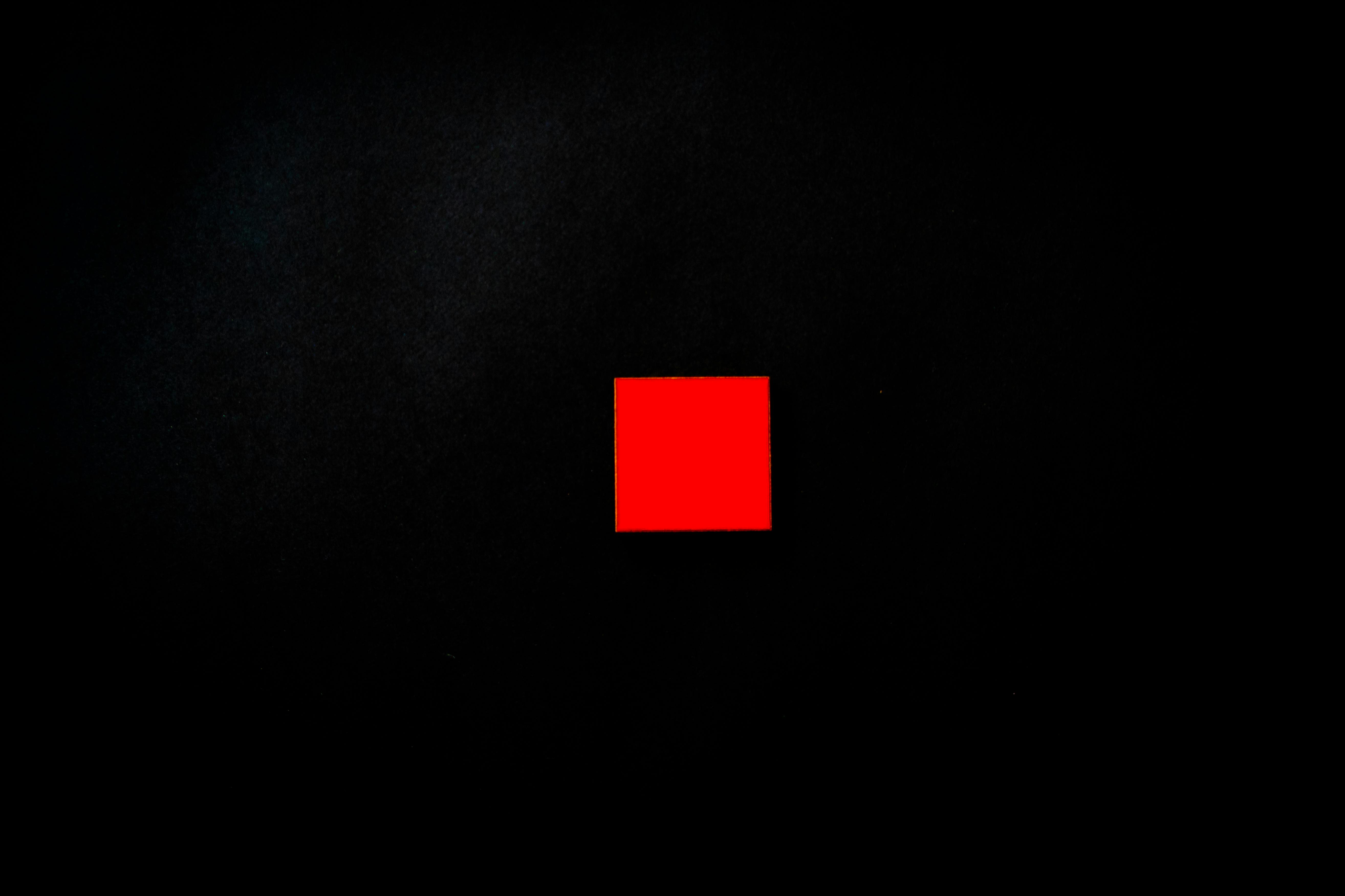 A black background containing safron square at the middle.