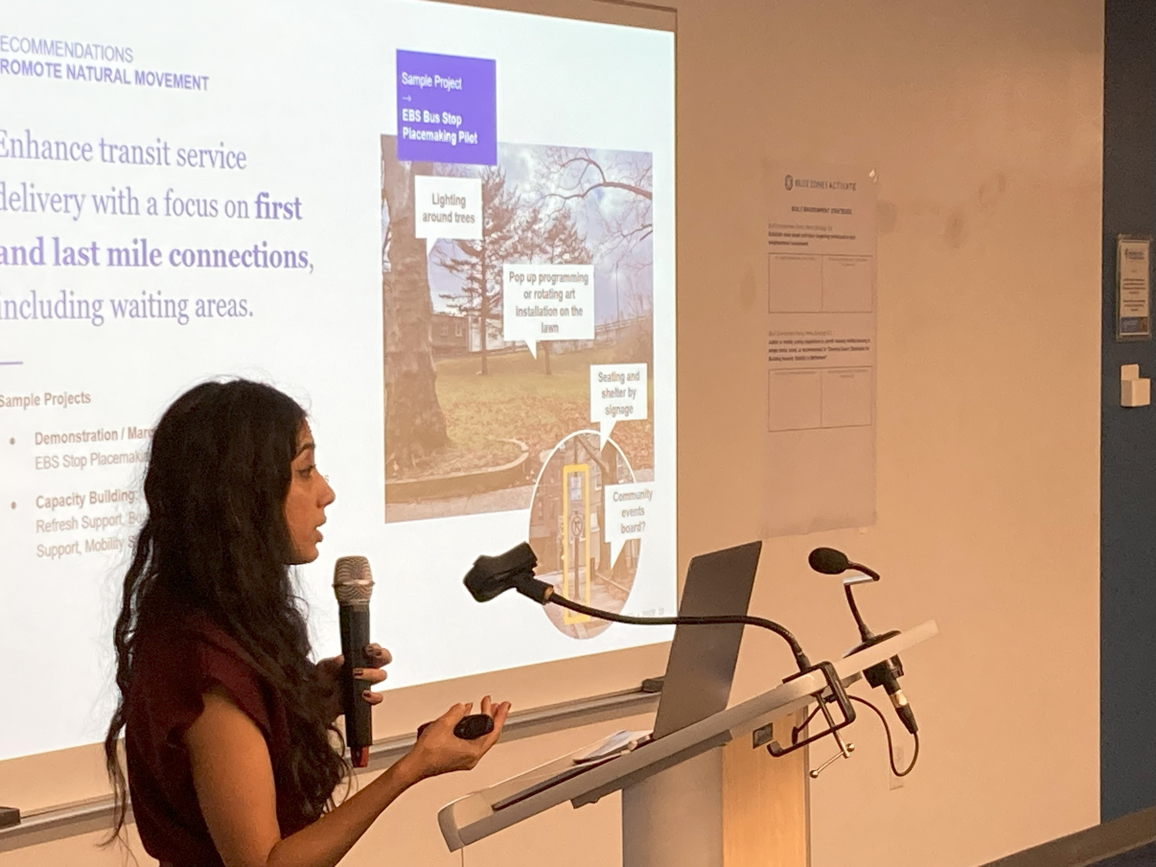 Modern home office setup with a monitor, ergonomic chair, keyboard, and indoor plants near a window with blinds.