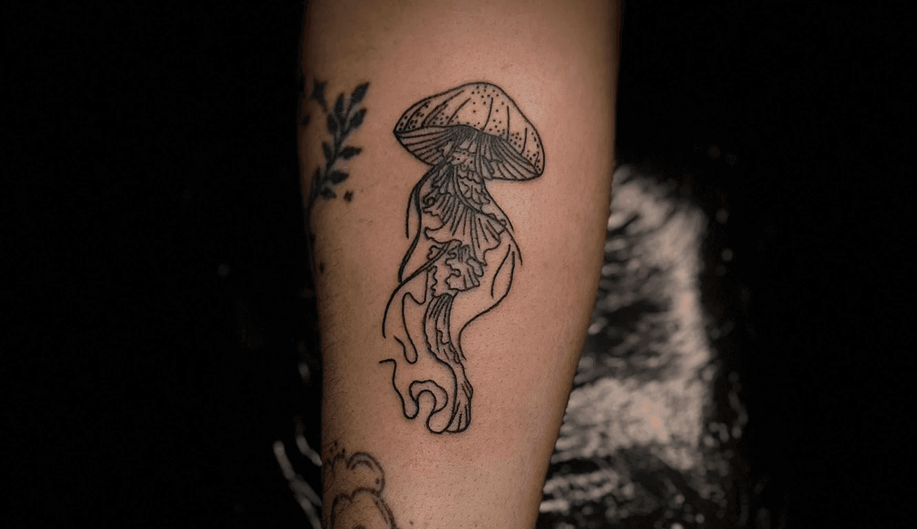 Artistic inner-arm tattoo showcasing a koi fish and sword combination adorned with delicate Japanese script and complemented by an existing heart design. Tattoo work by Jai, Bloodworks Tattoo Studio, Auckland.