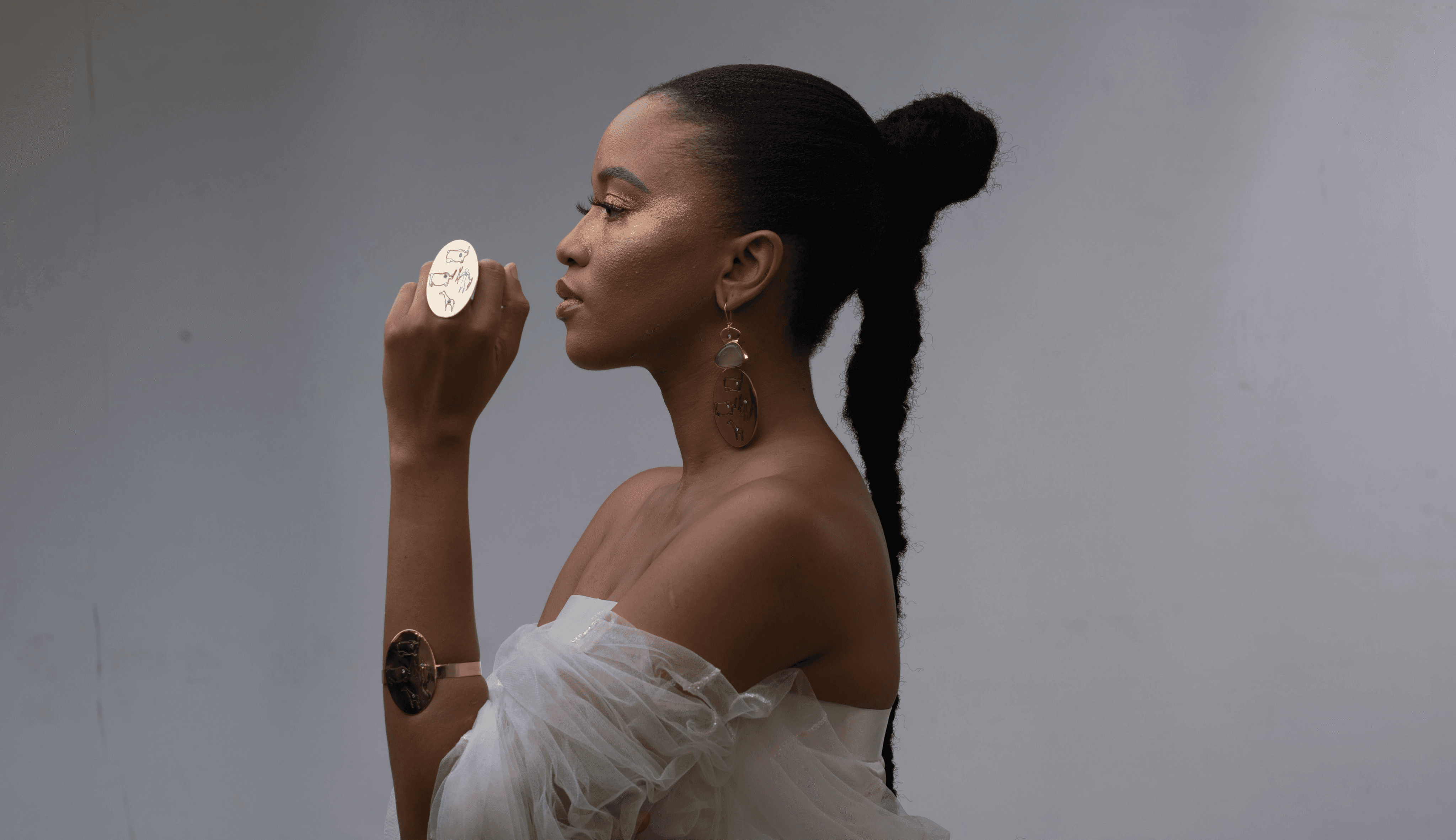 Profile picture of a beautiful woman wearing a white dress and beautiful jewellery