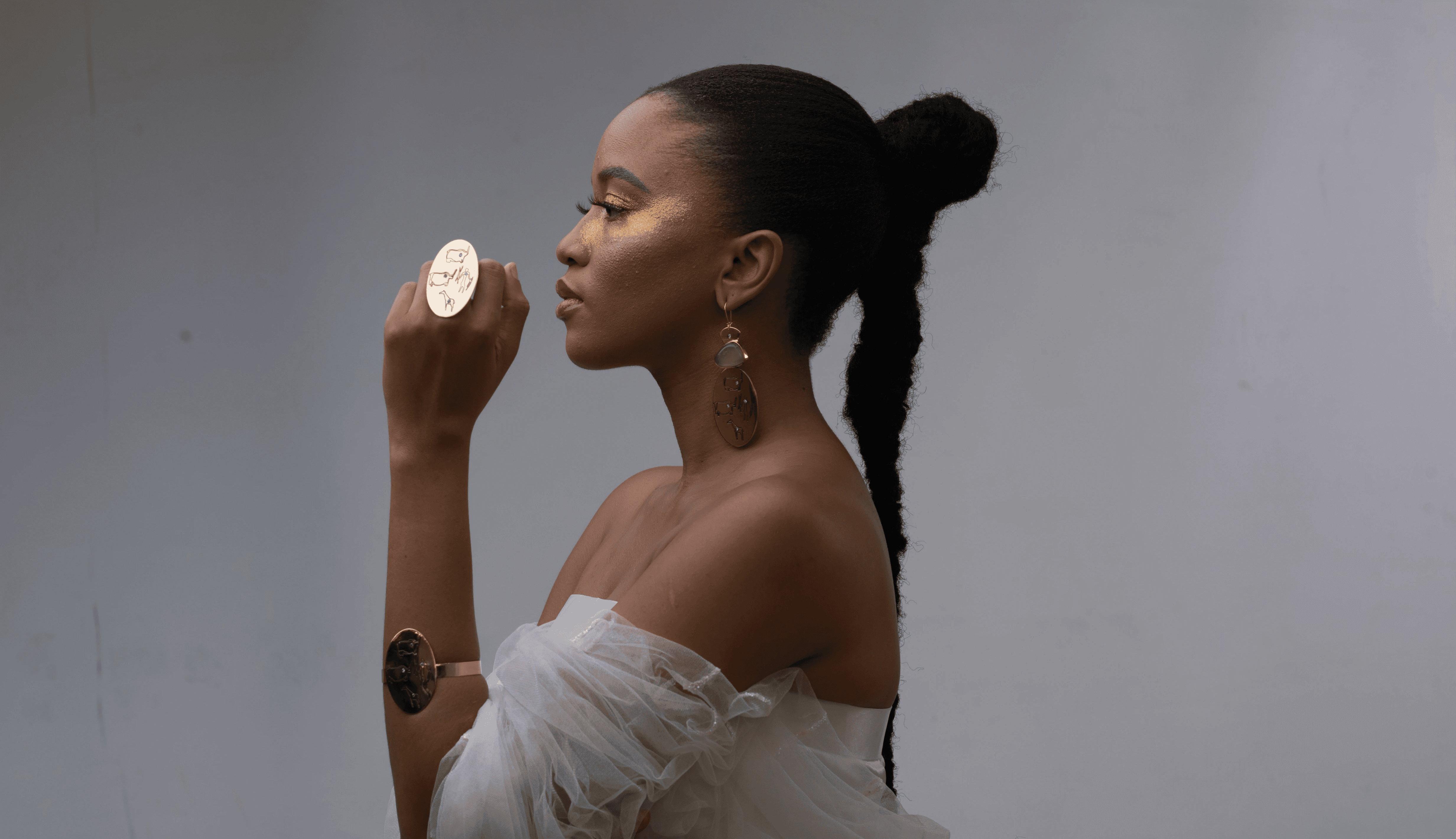 Profile picture of a beautiful woman wearing a white dress and beautiful jewellery