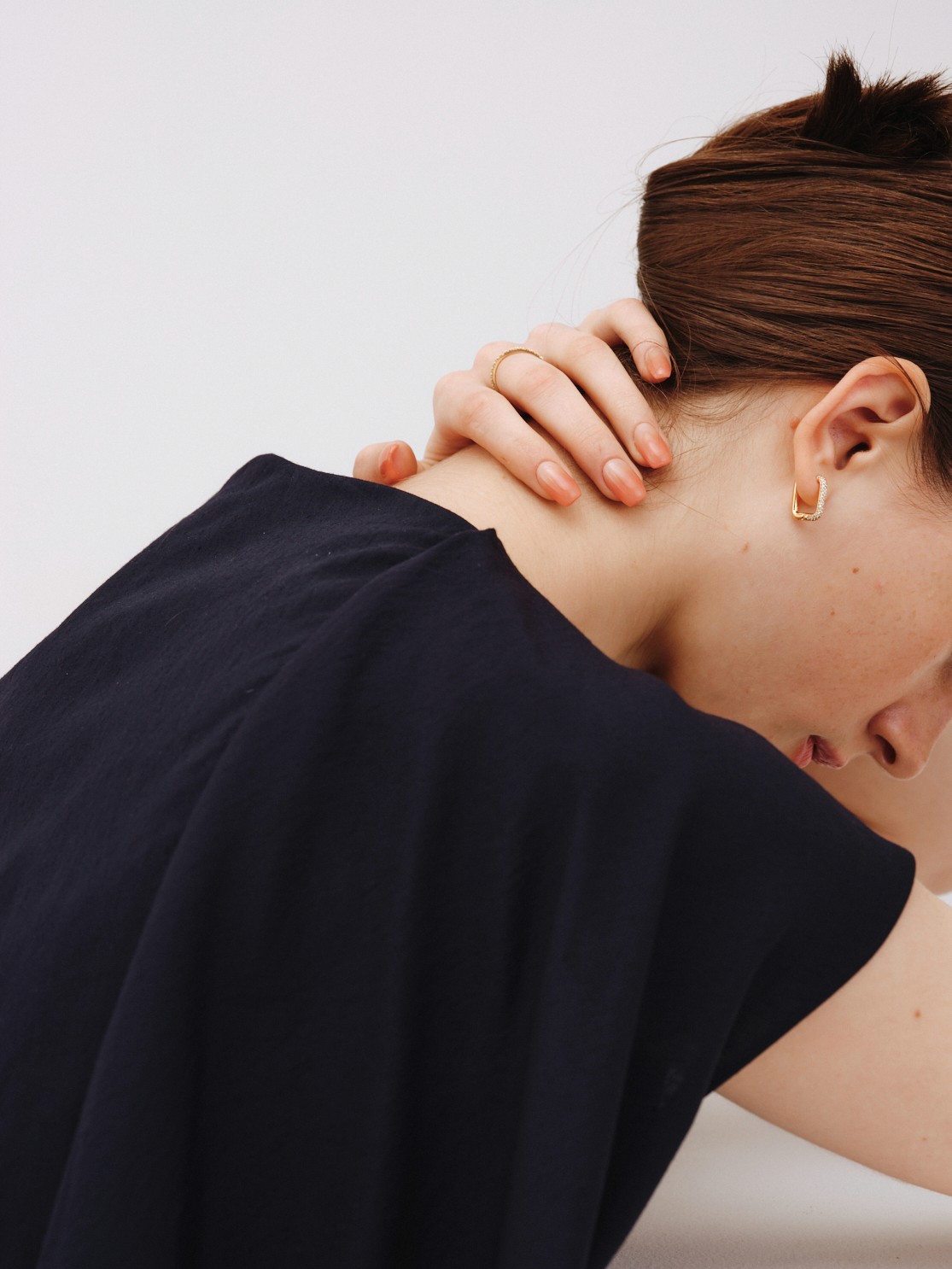 Close beauty portrait of two women with freckles and bold red lipstick in soft natural light.