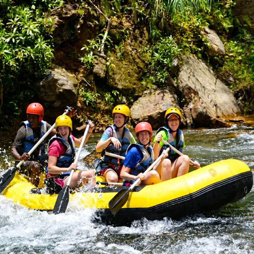 A group is heading down the fast water river rapids in Fiji near Pacific Harbour