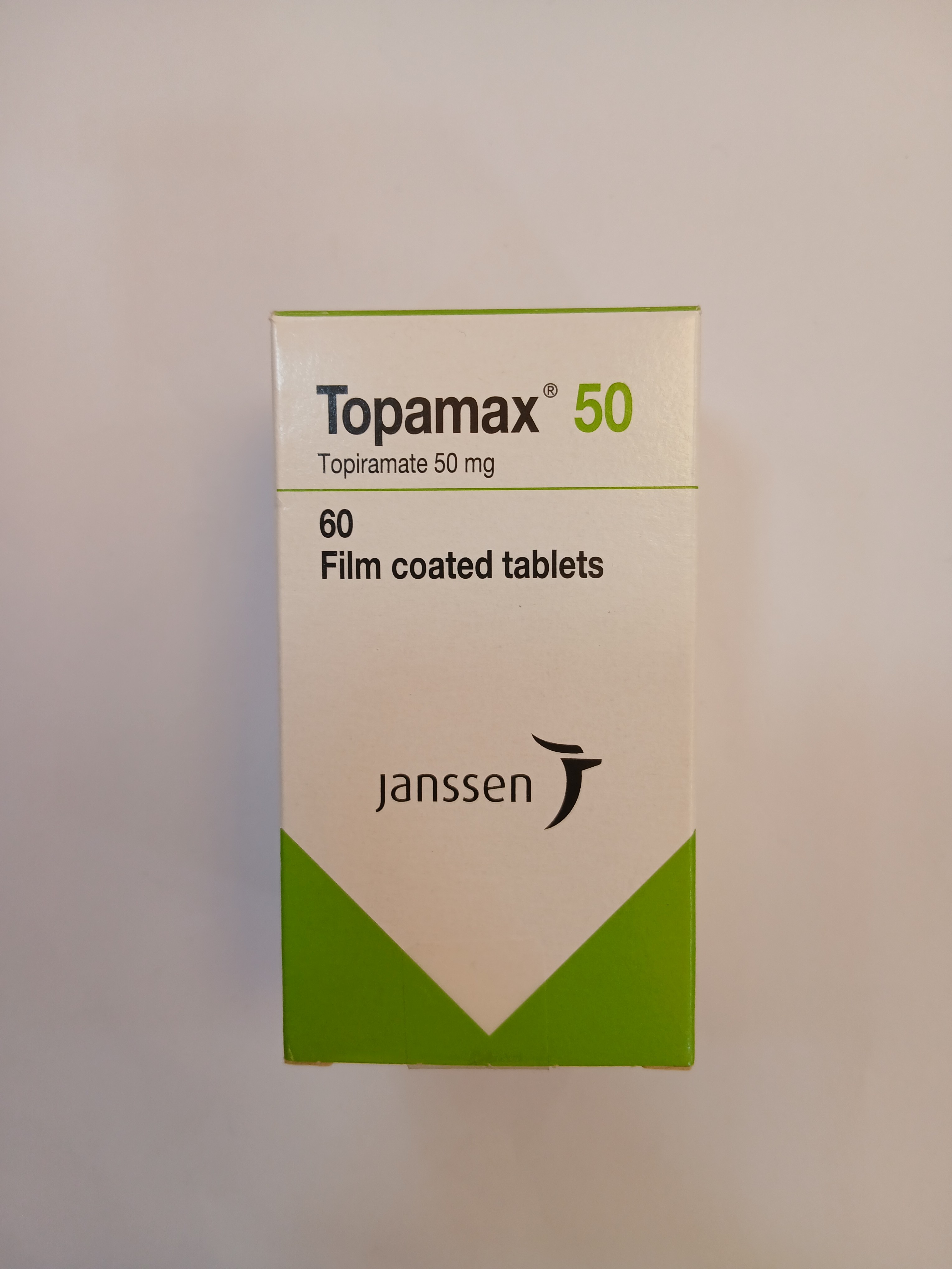 A white and green cardboard box packaging contains 60 film-coated tablets, with the bottom half of the box colored in green and the top half in white.