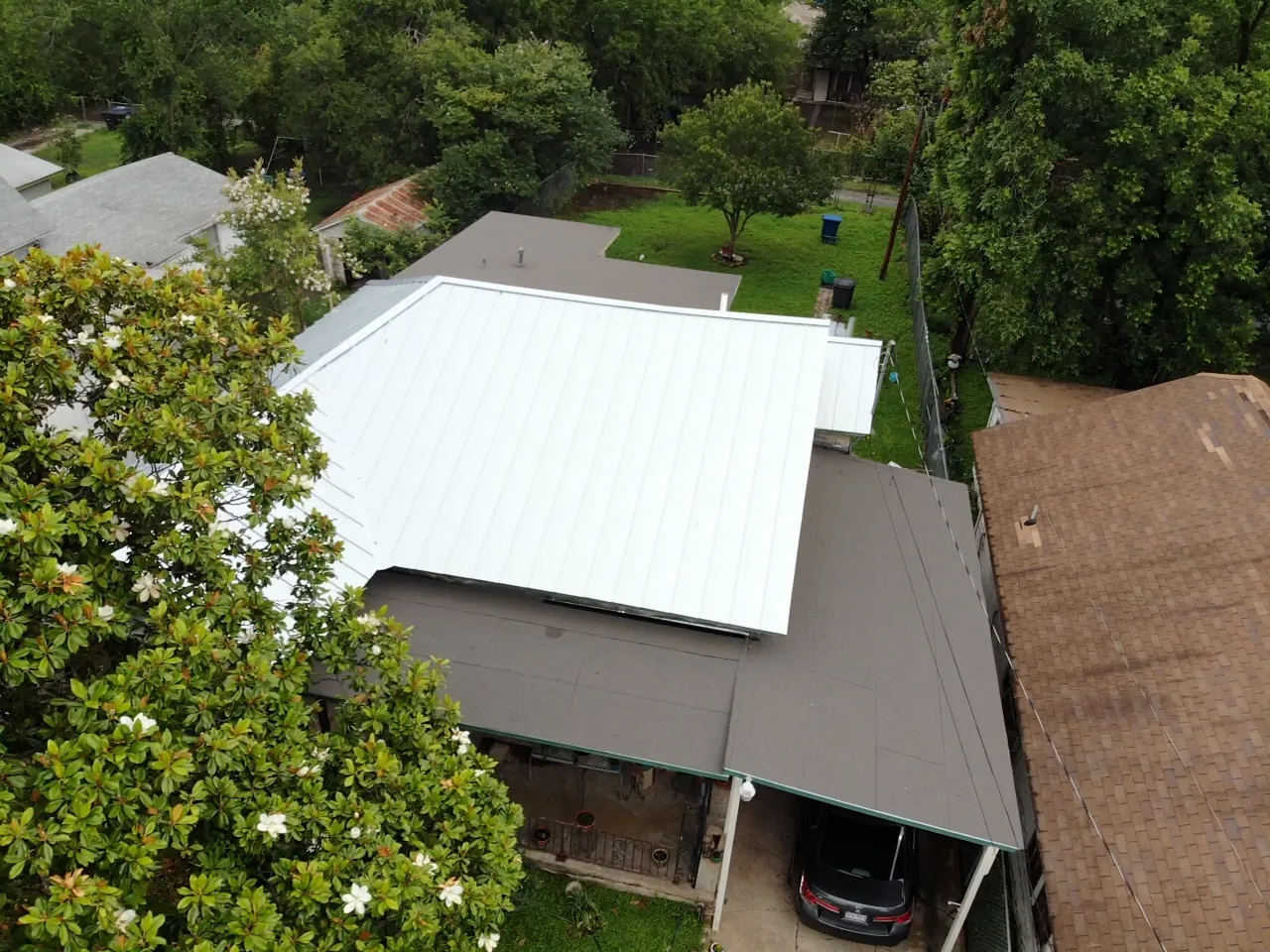 After - another angle: green shingles to silver metal.