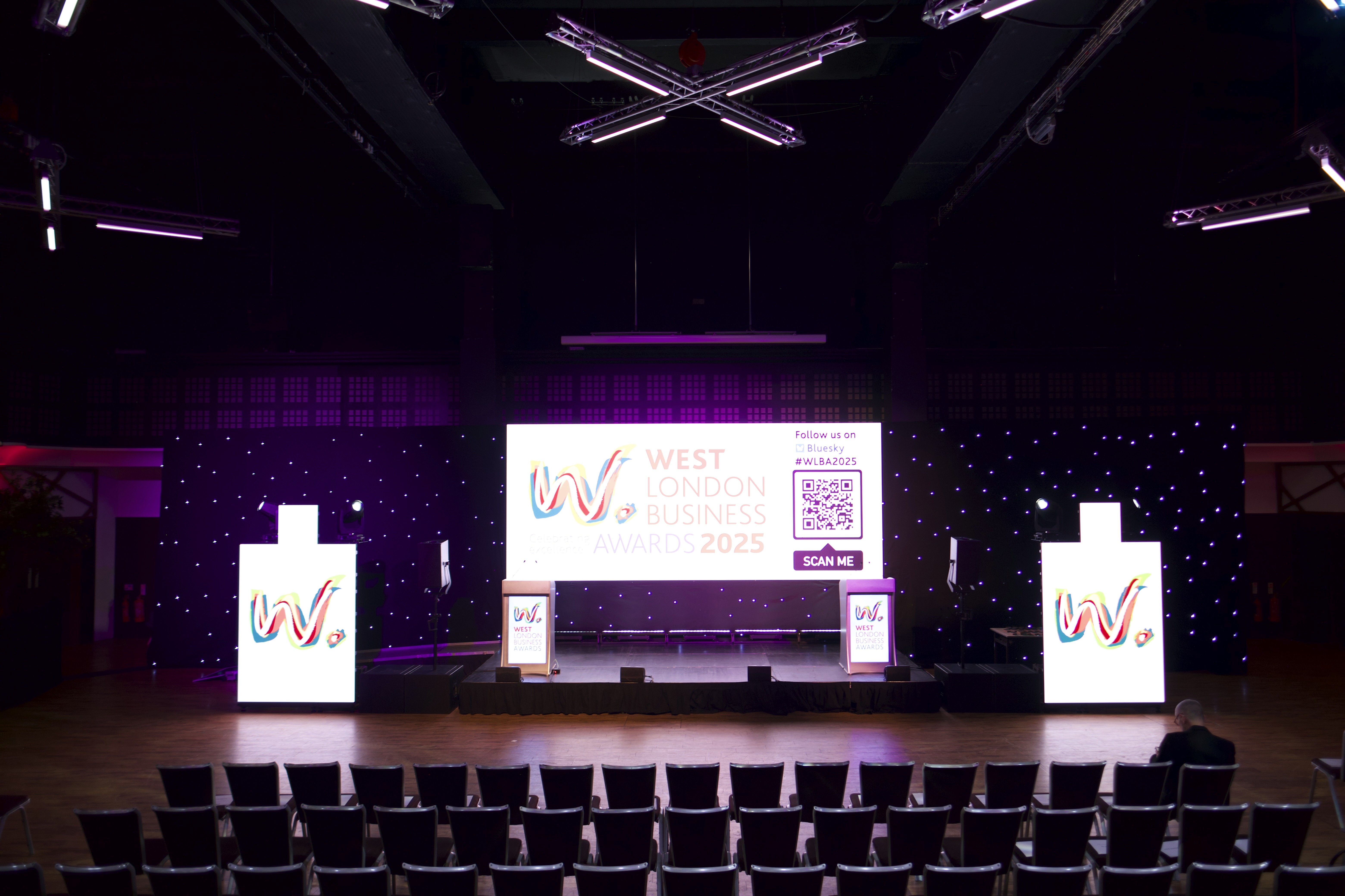 Stage Engage stage production for the West London Business Awards 2025, featuring LED screens, starcloth backdrop and event lighting.