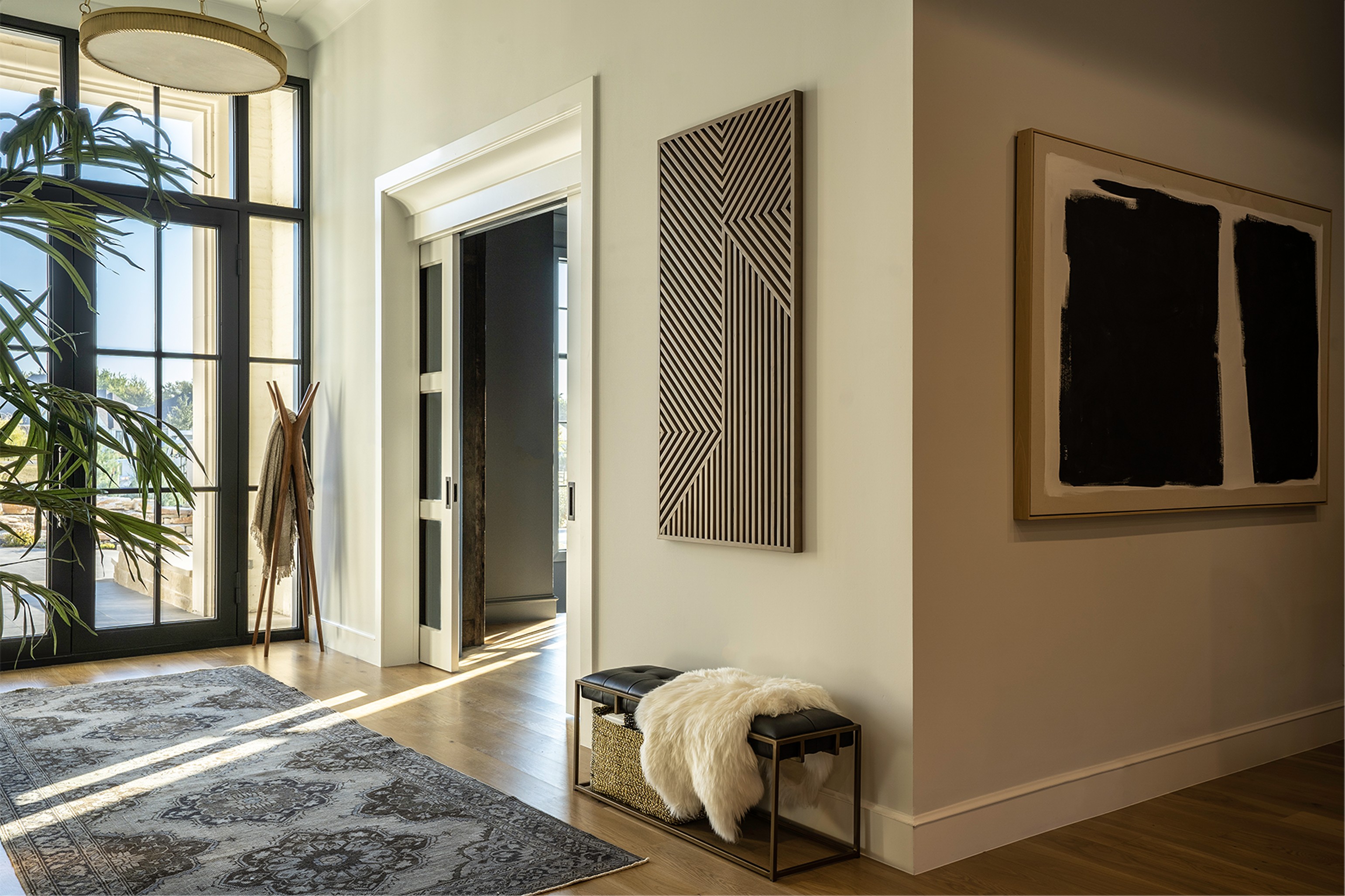 Fairview primary suite bathroom with copper freestanding tub, crystal chandelier, and hexagonal tile accent wall