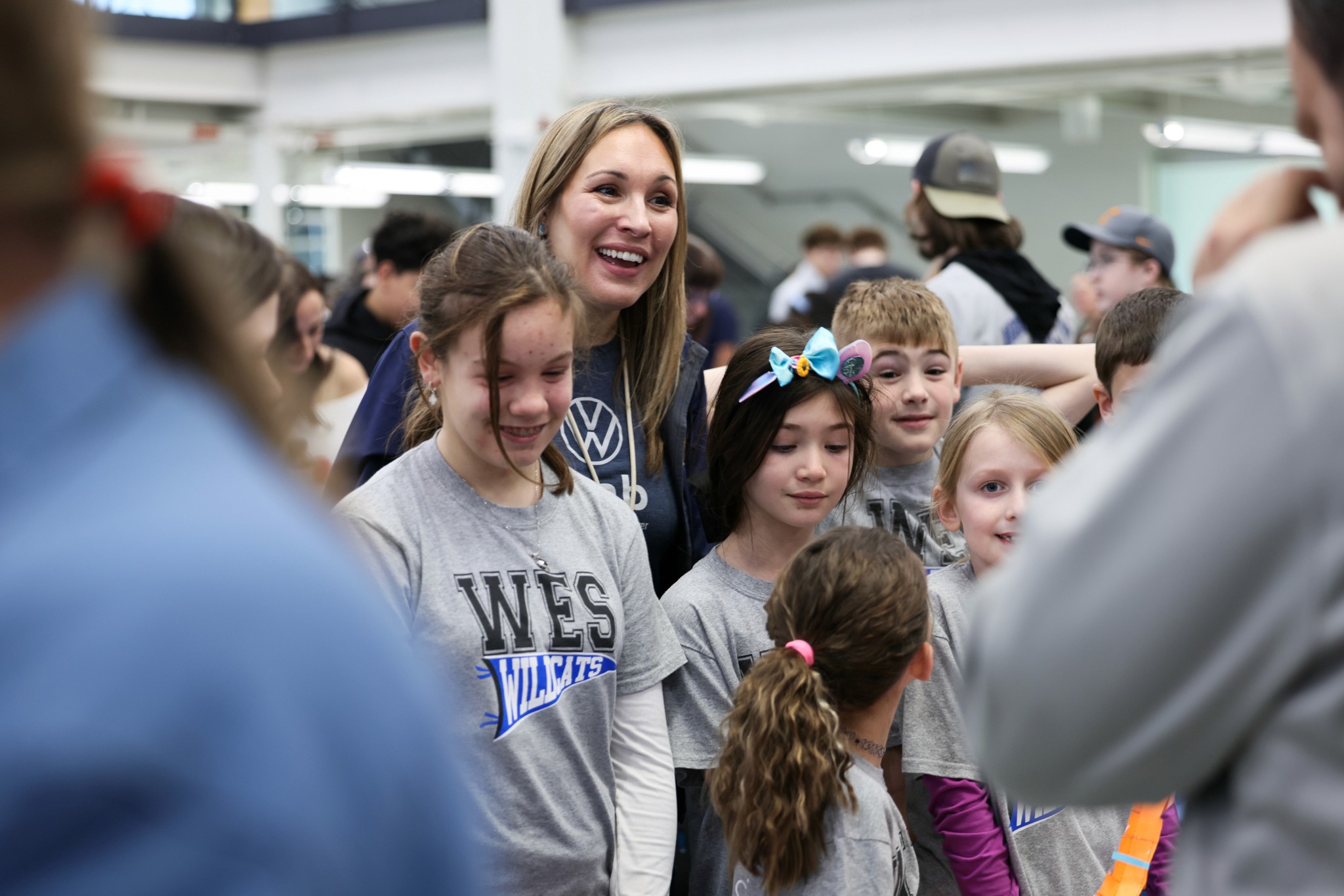 WVeLab teach and children standing together looking at presentations during the annual WVeLab showcase