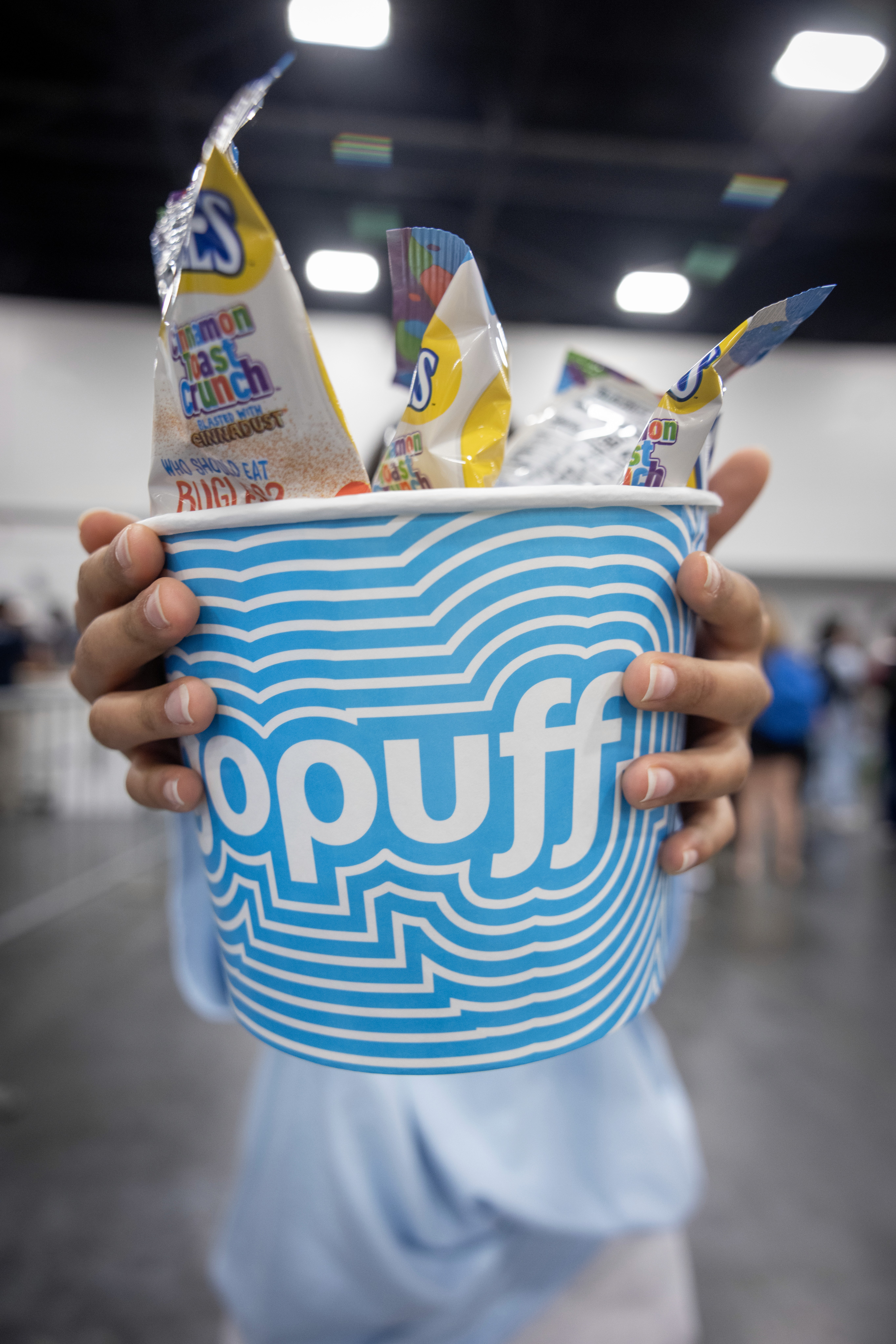 Two hands hold a Gopuff branded bucket with snacks inside at the Style Saves Miami event. Credit: World Red Eye 