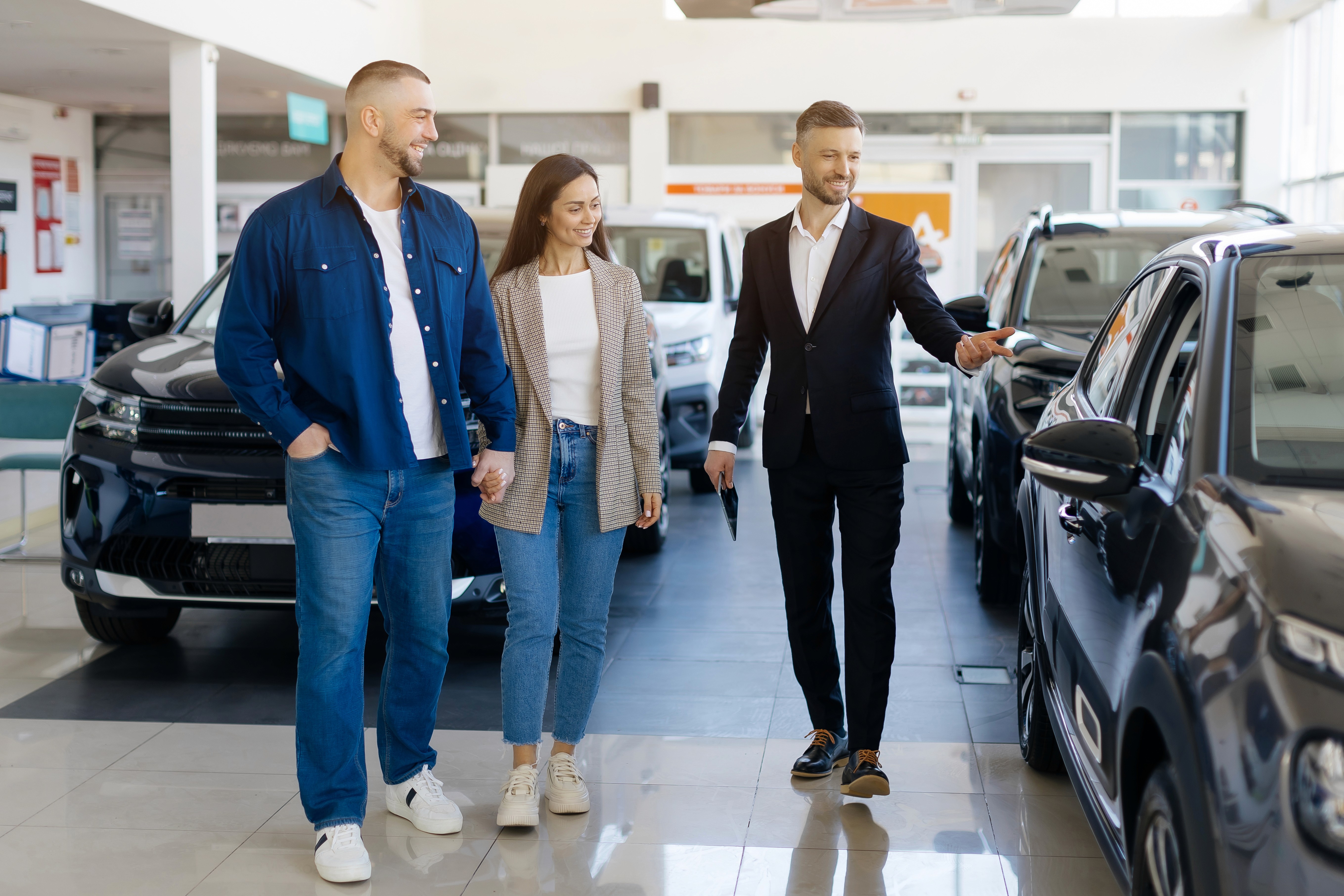 A salesman showing a family their new car