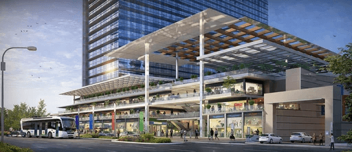 Wide outdoor shopping walkway featuring double-height storefronts and premium brand signage