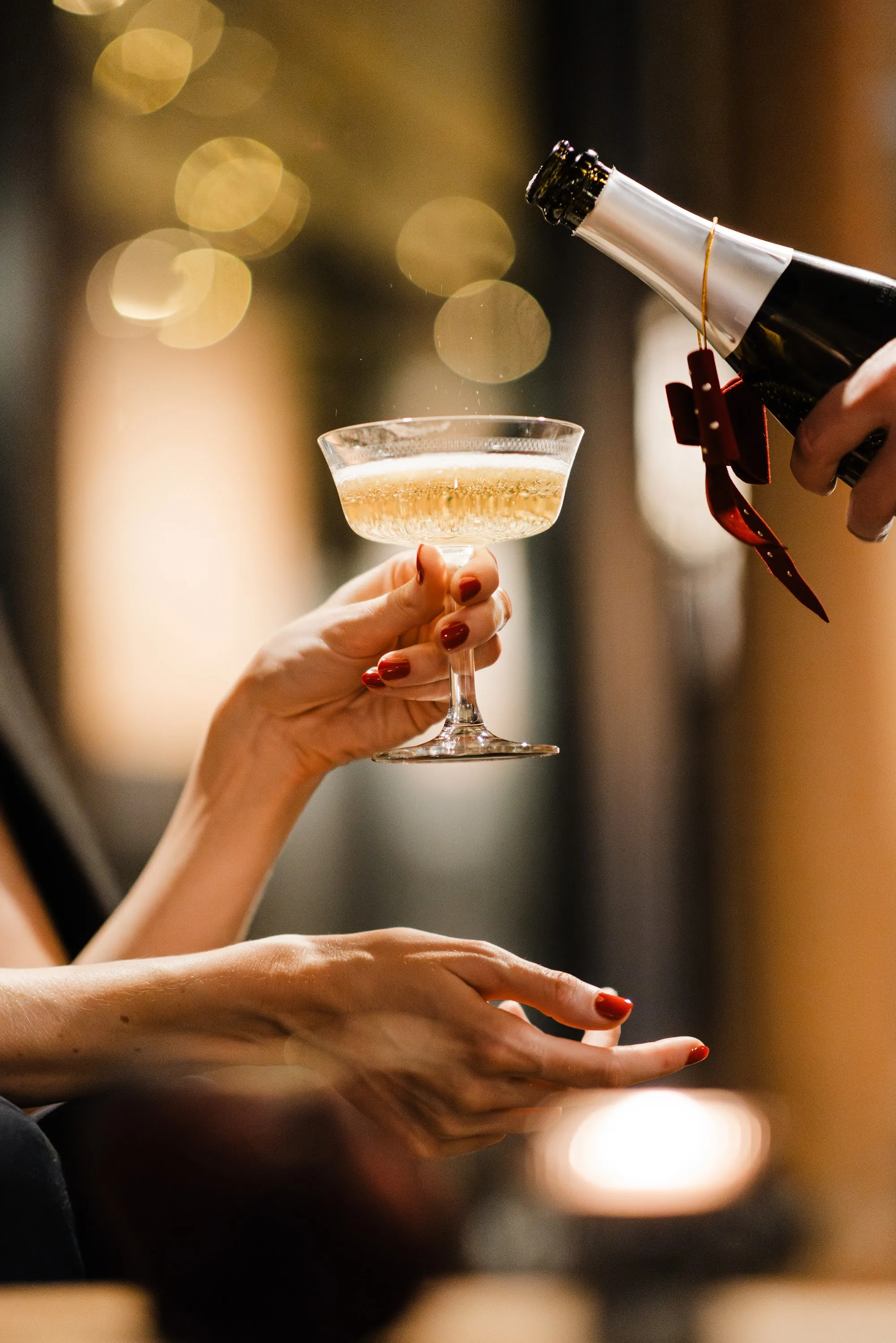 Sparkling wine being poured into a coupe glass at Exeter Hotel