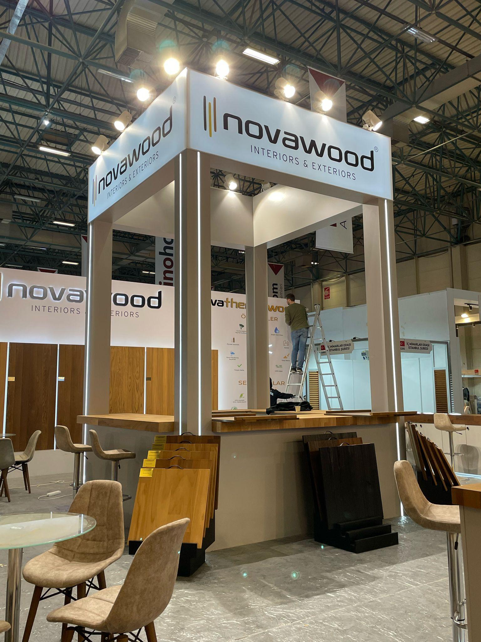 Central branded structure at the Novawood stand, featuring illuminated logos and a modern, welcoming design.
