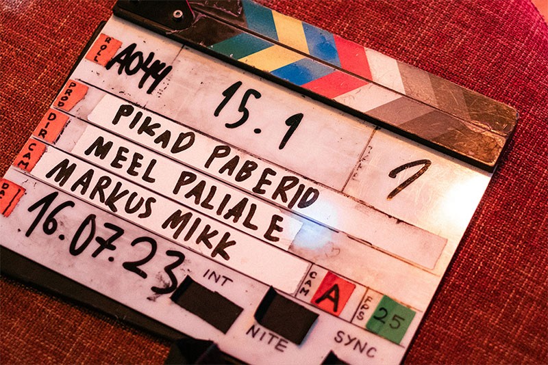 A clapperboard marks the start of a new take during the filming of Rolling Papers (Pikad paberid), behind-the-scenes movie action with Director Meel Paliale
