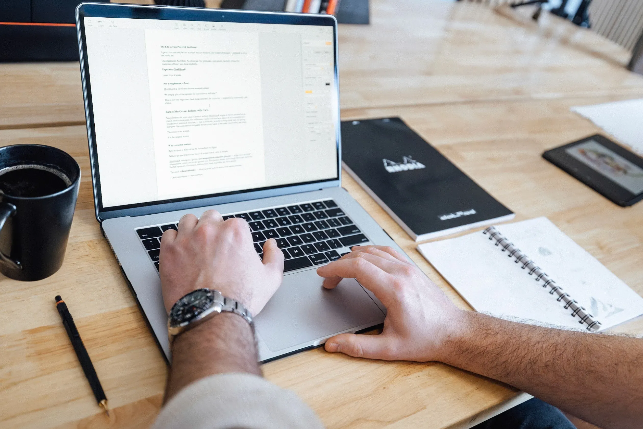 Person in a white off-shoulder top using a MacBook laptop, with text overlay 'What's new in digital?' and the fabrica® logo in the top corner.