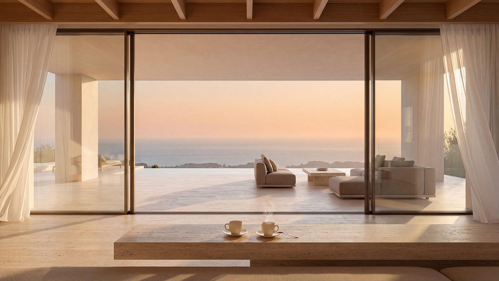 Minimalist luxury villa interior in Marbella with panoramic sea view and two coffee cups in the foreground at sunrise