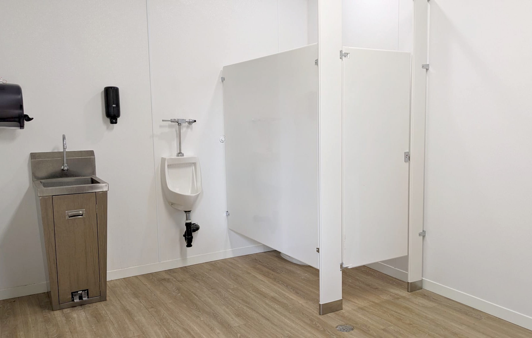 Angle 2 of commercial bathroom installation with cubicle, urinal and sink