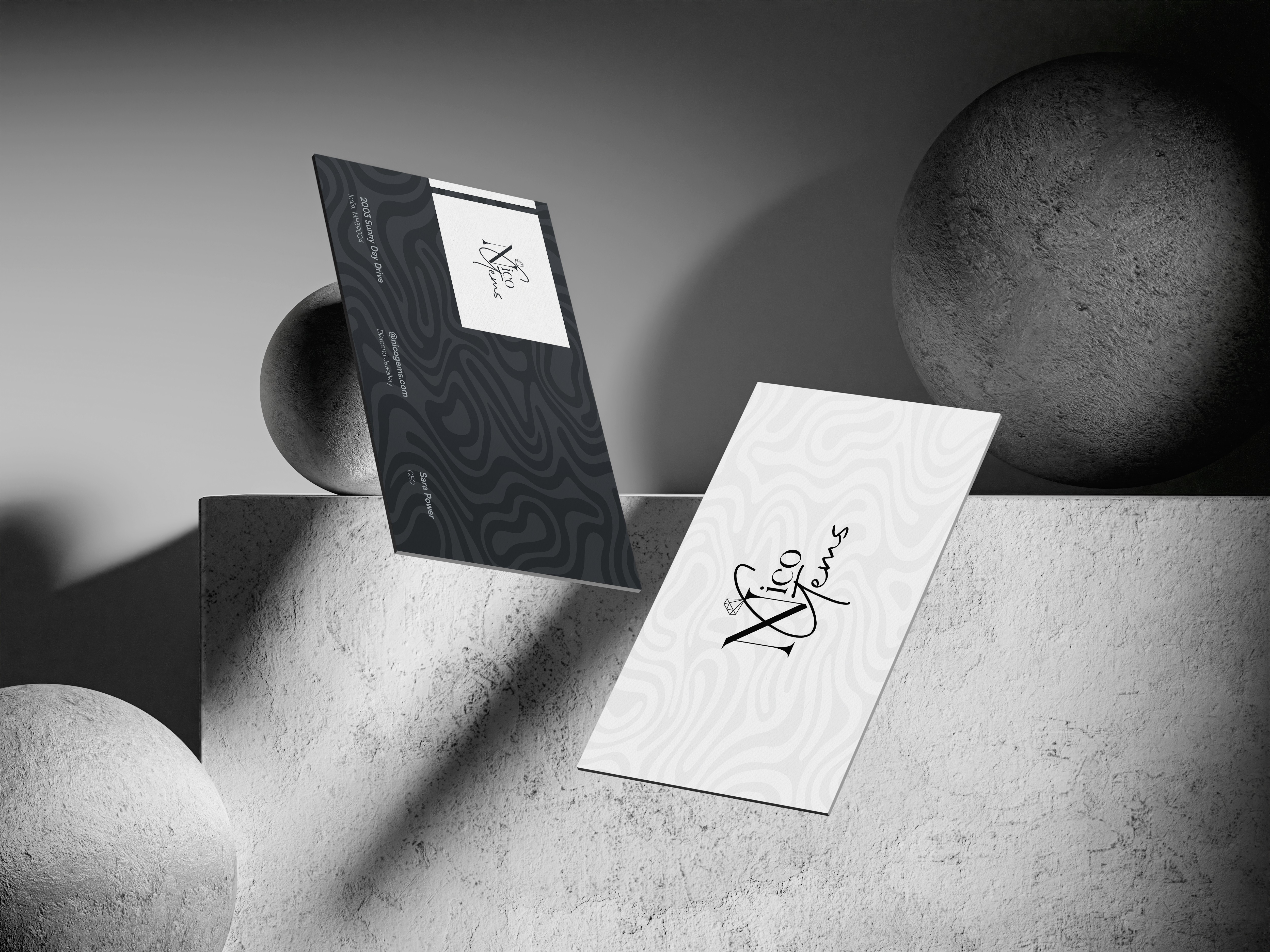 Two business cards on a podium. The cards display the "Nico Gems" logo and contact information.