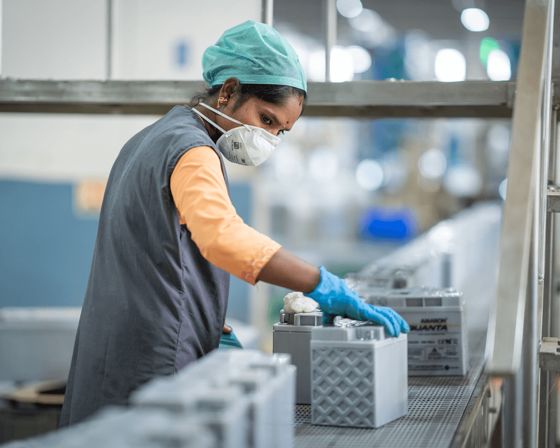 Factory workers operating machinery in an industrial photography shoot.