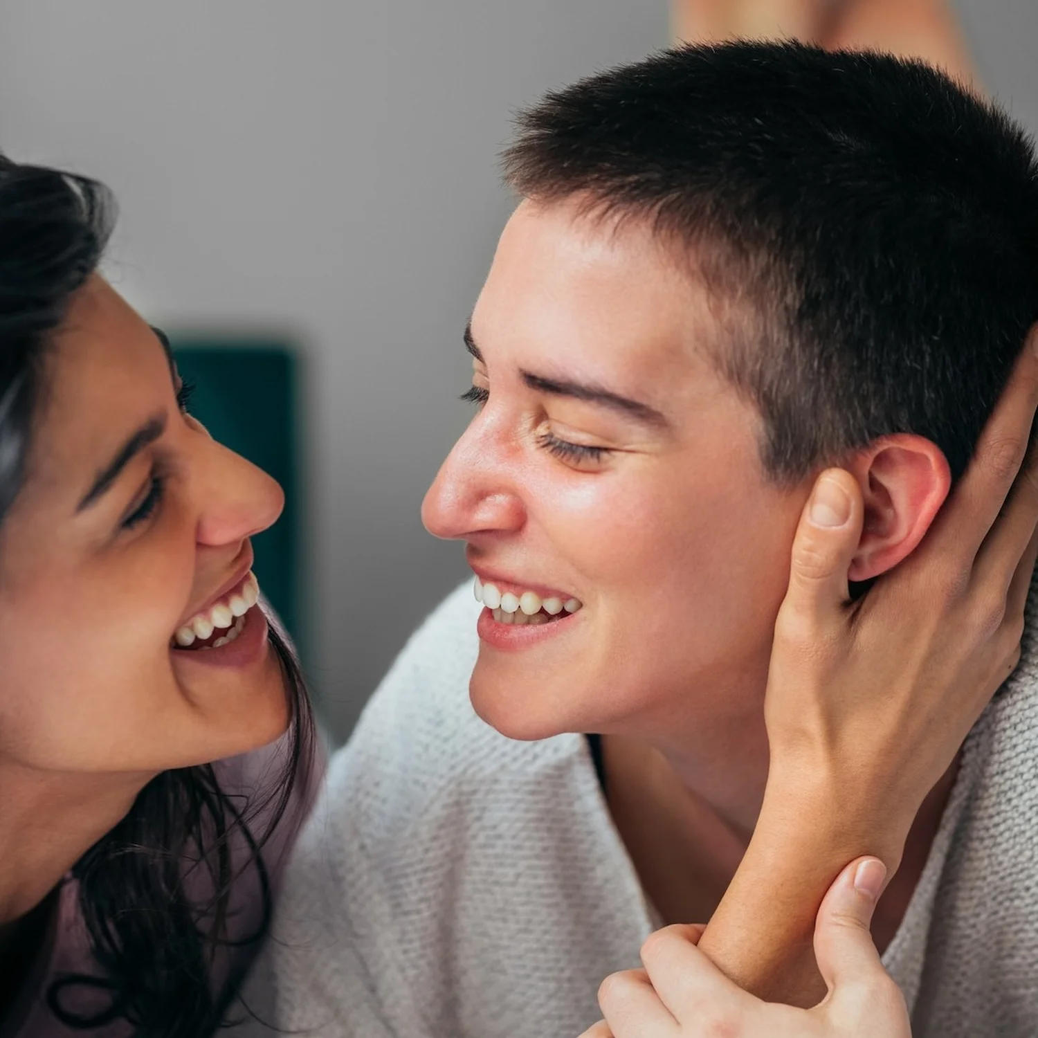 Two people smiling and connecting closely, symbolizing emotional intimacy and self-discovery through sexuality exploration therapy in Los Angeles.