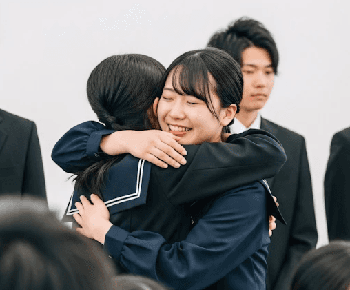 International students hugging during arrival support in the UK.