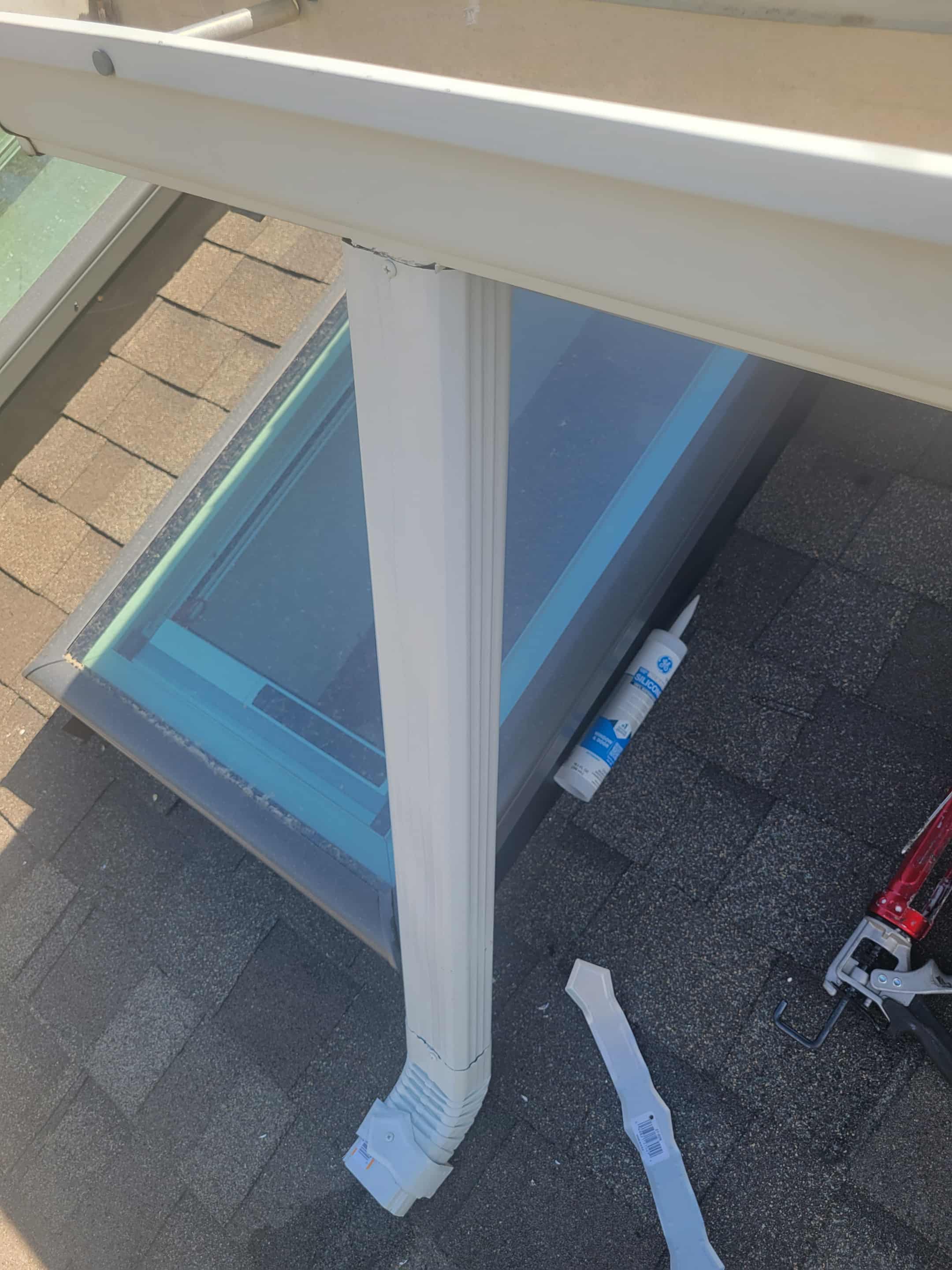 Close-up of a white support column positioned above a blue surface with visible construction materials nearby.