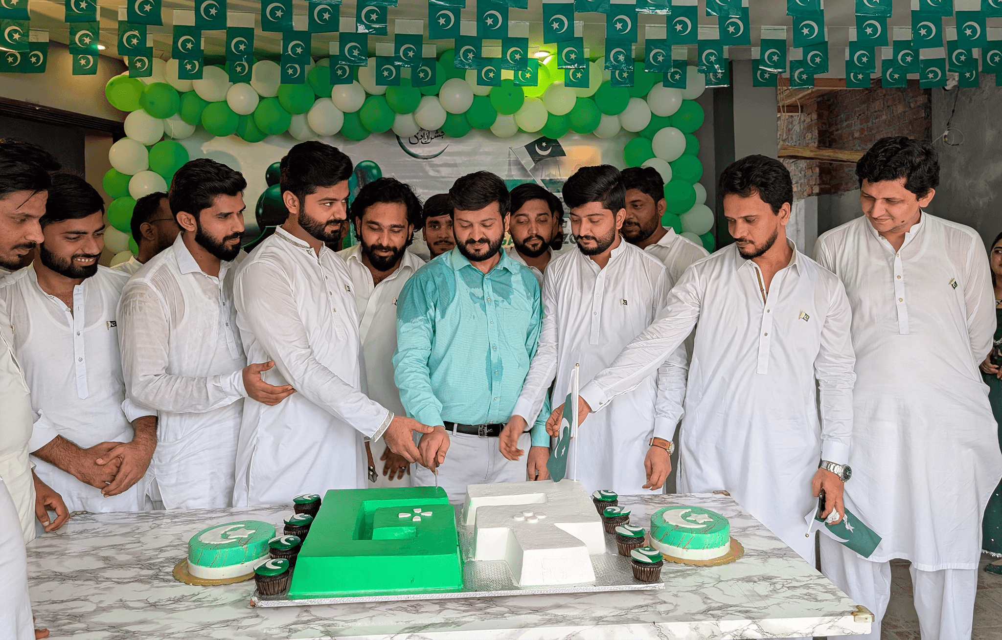 three men sitting while using laptops and watching man beside whiteboard