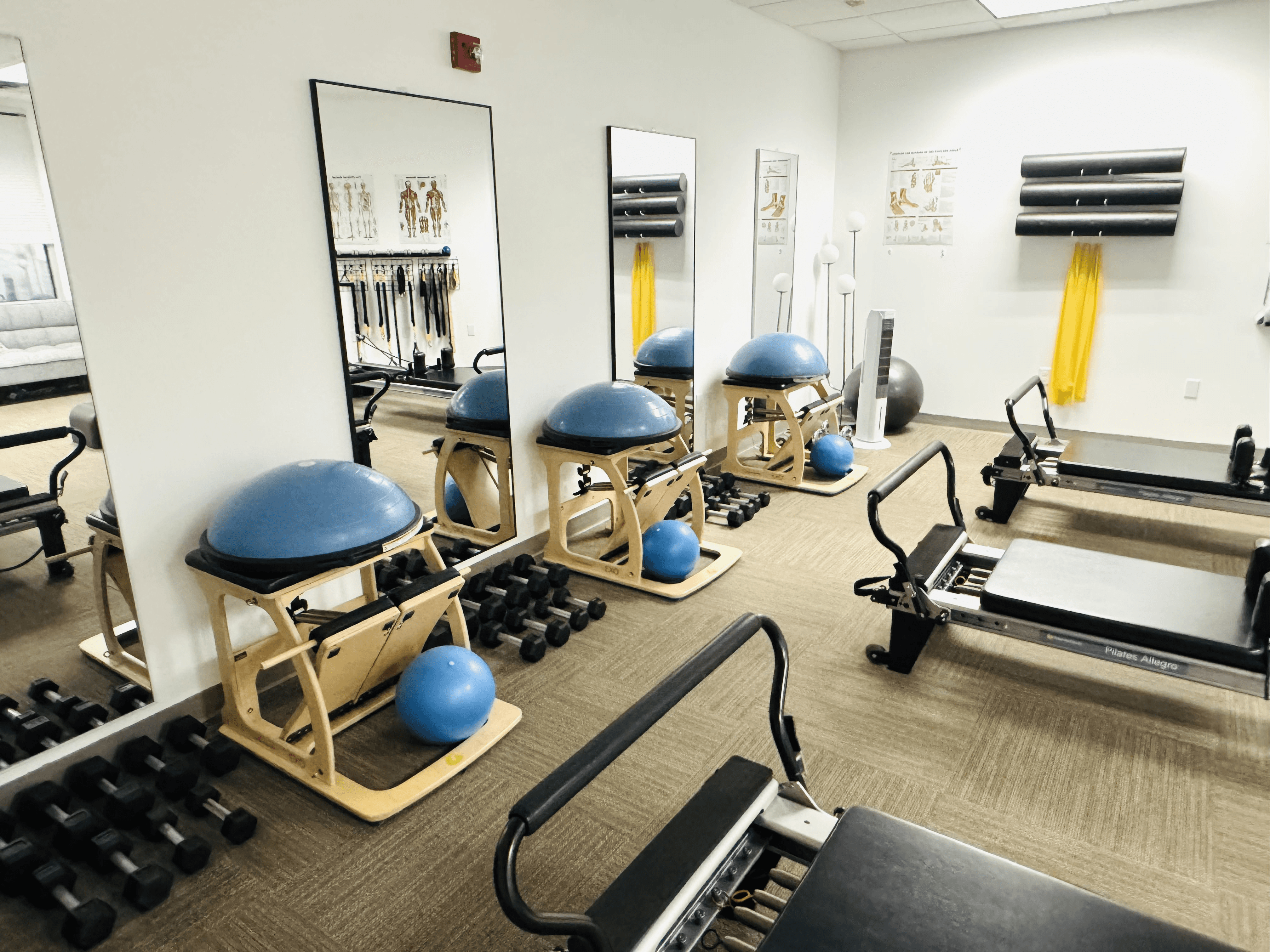 a woman is doing a piyoma exercise in a gym