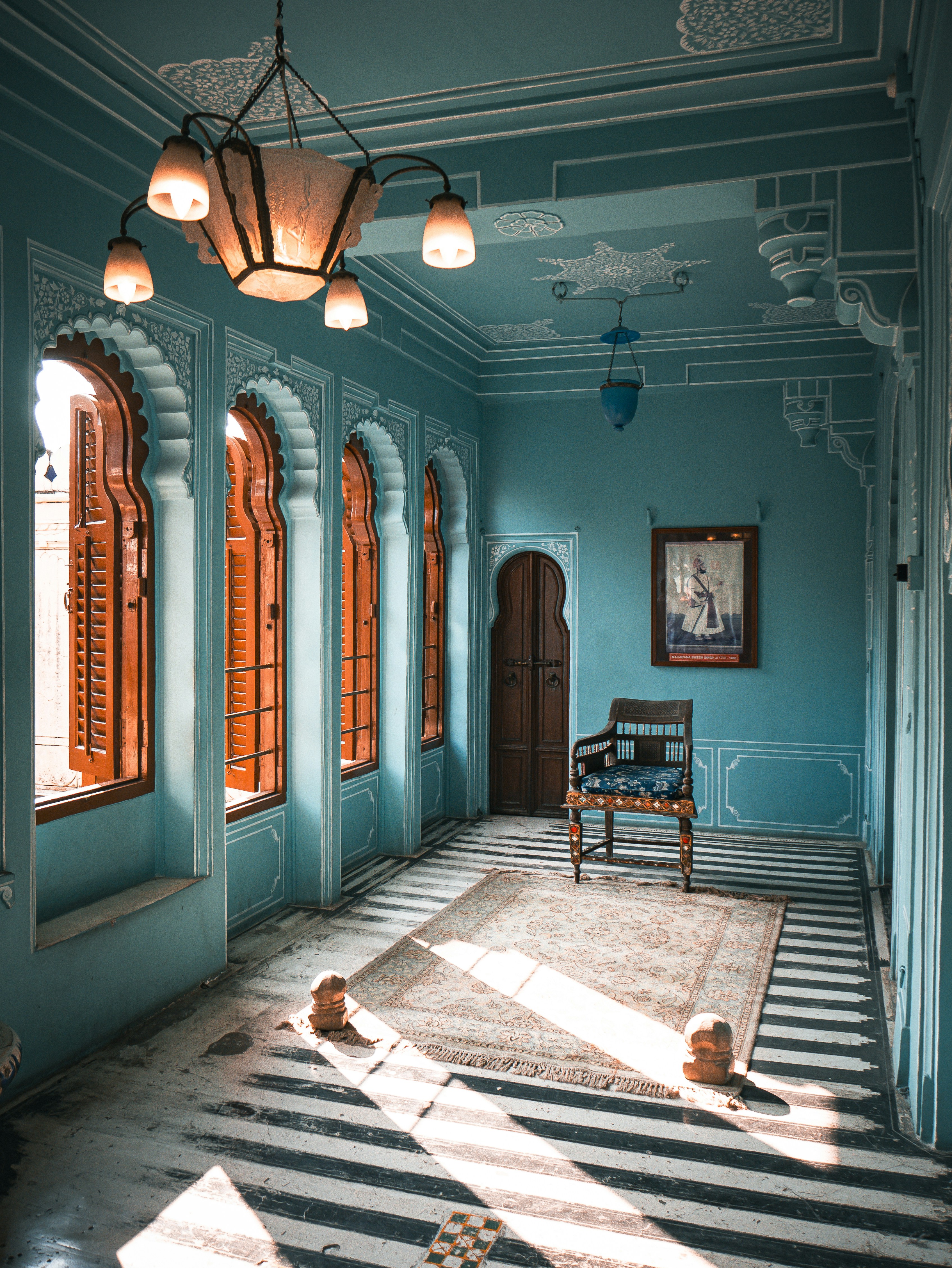 A room with a striped floor and blue walls