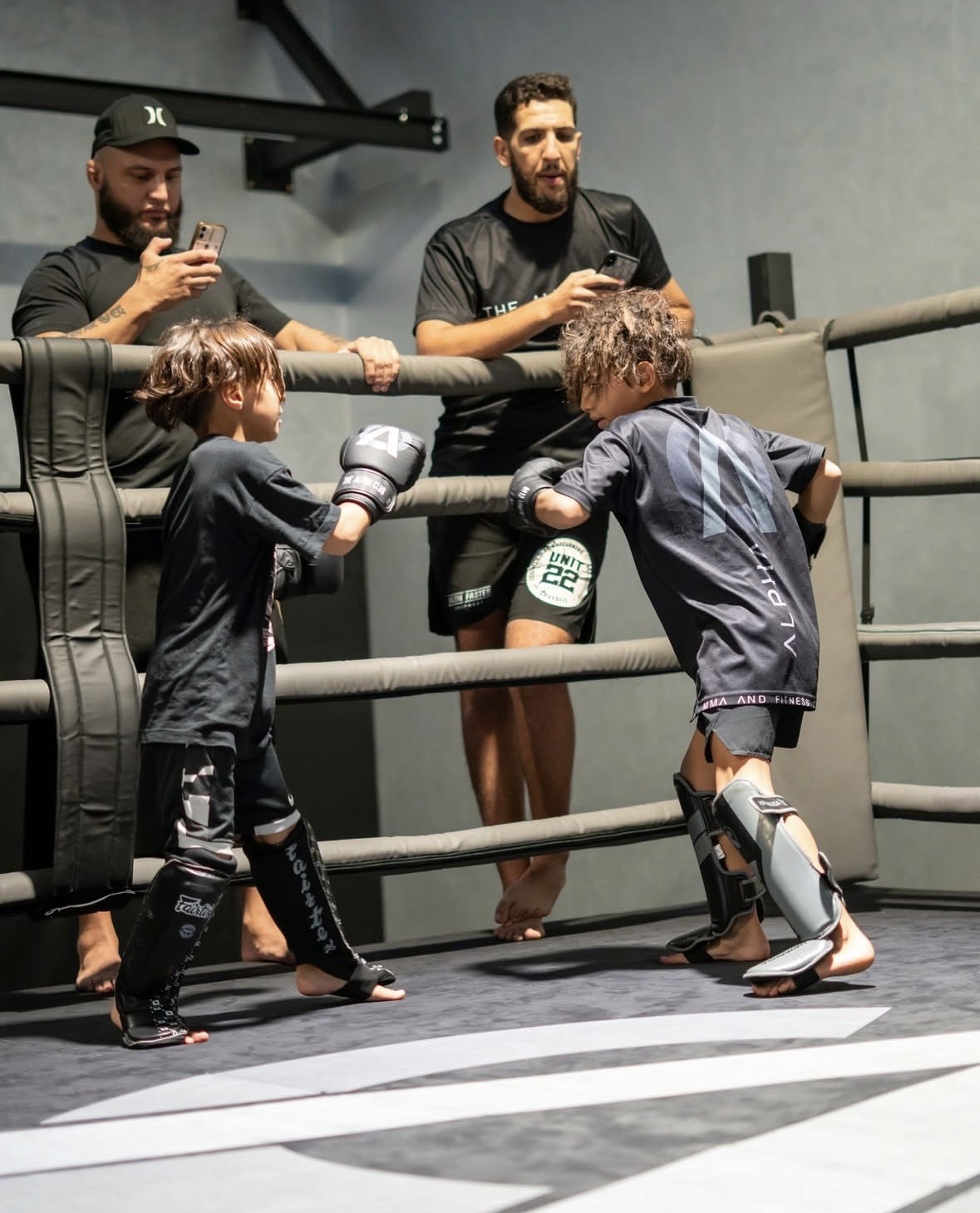 Photo of Evo X founder Deri Morgan seated outdoors at sunset with ocean view in the background