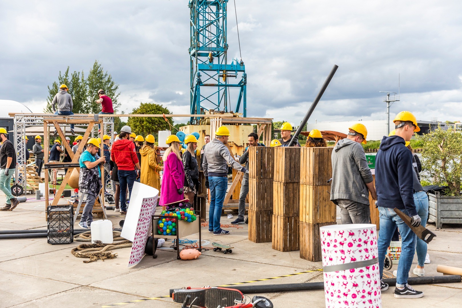 Teams in yellow helmets build their section of the Chain Reaction