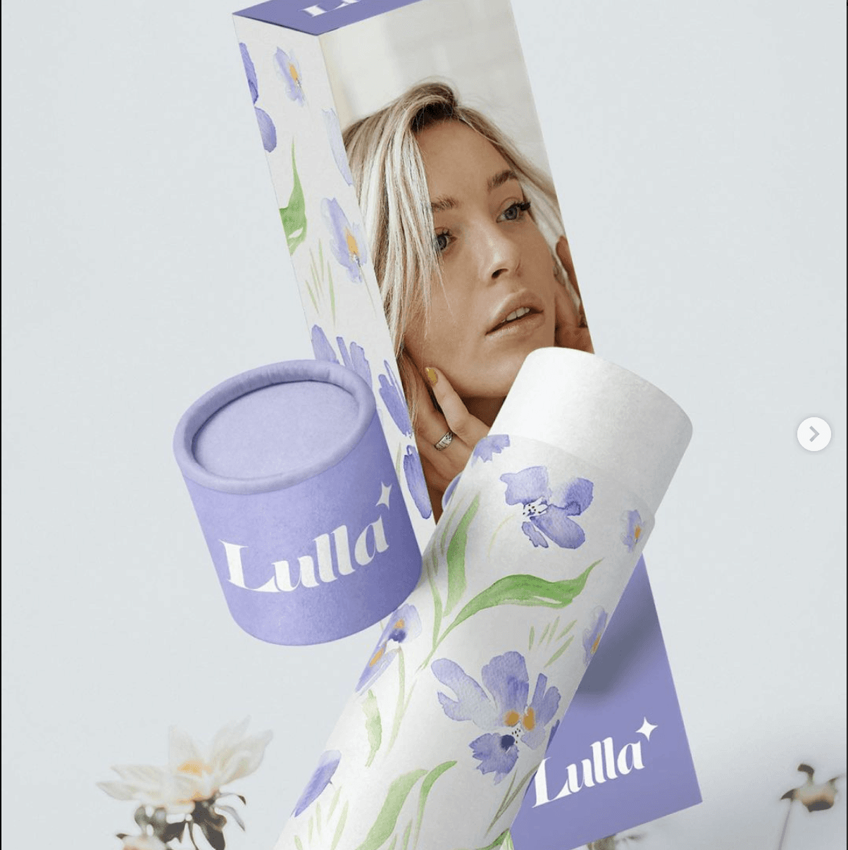 Product packaging featuring floral design, with a portrait of a woman, on a light background.