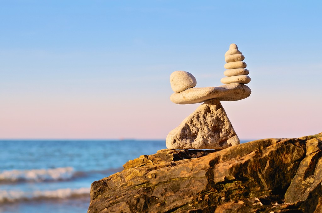 Balancing pebbles on top of a stone