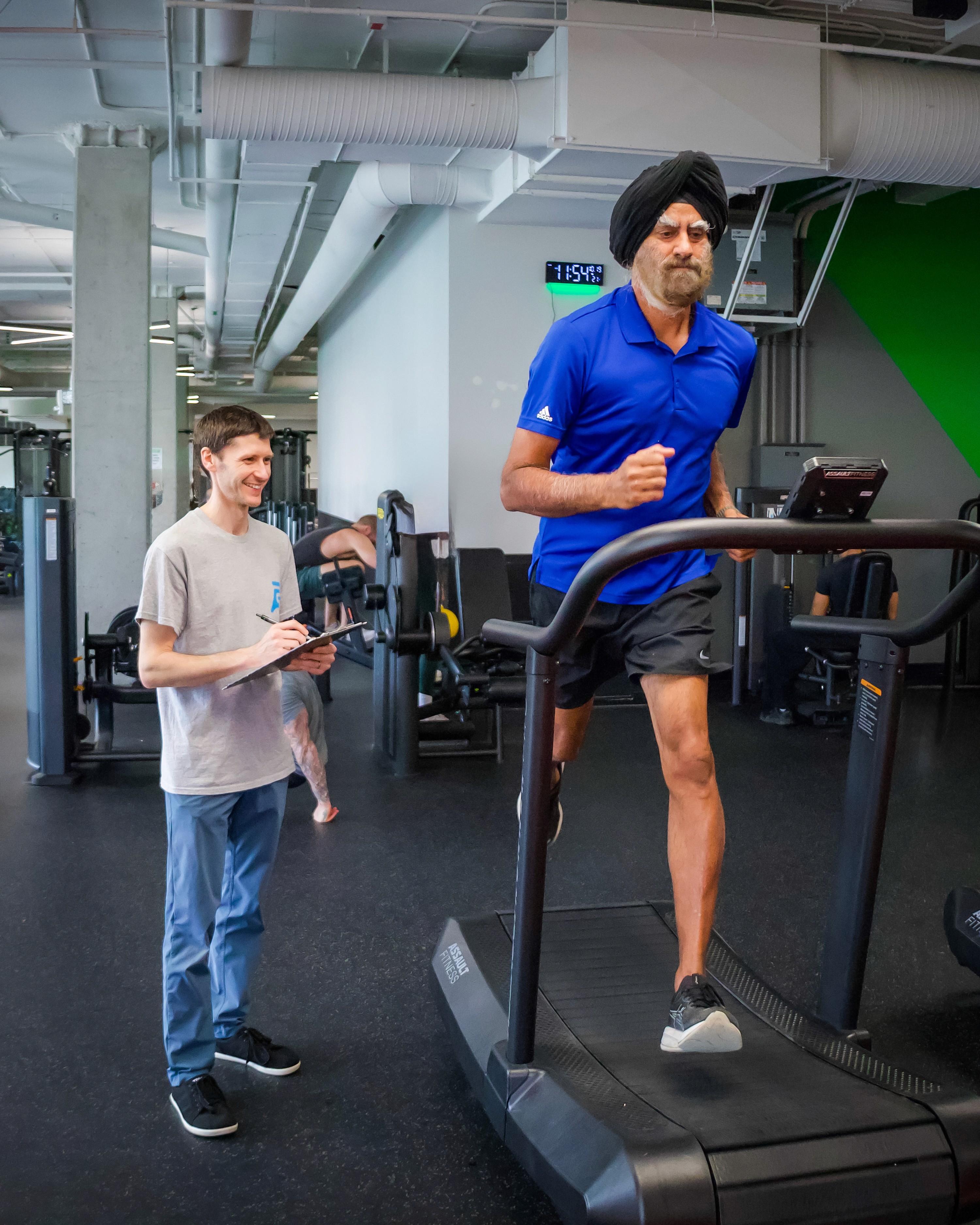 physiotherapist assessing runner's gait and taking notes