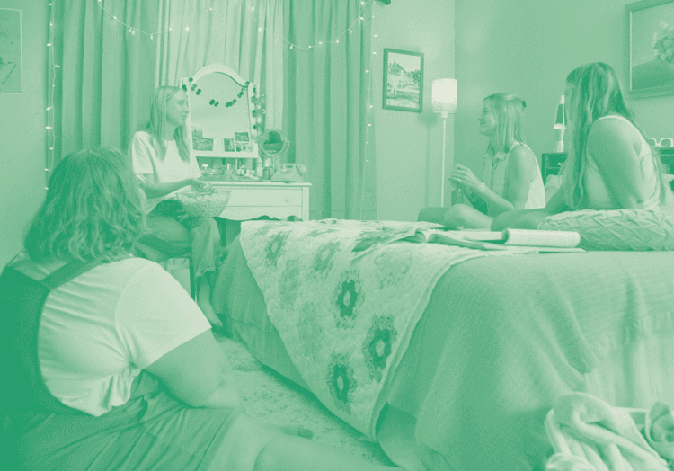 Duotone photo of the Kidsister team laughing and hanging out in a 90s-style bedroom