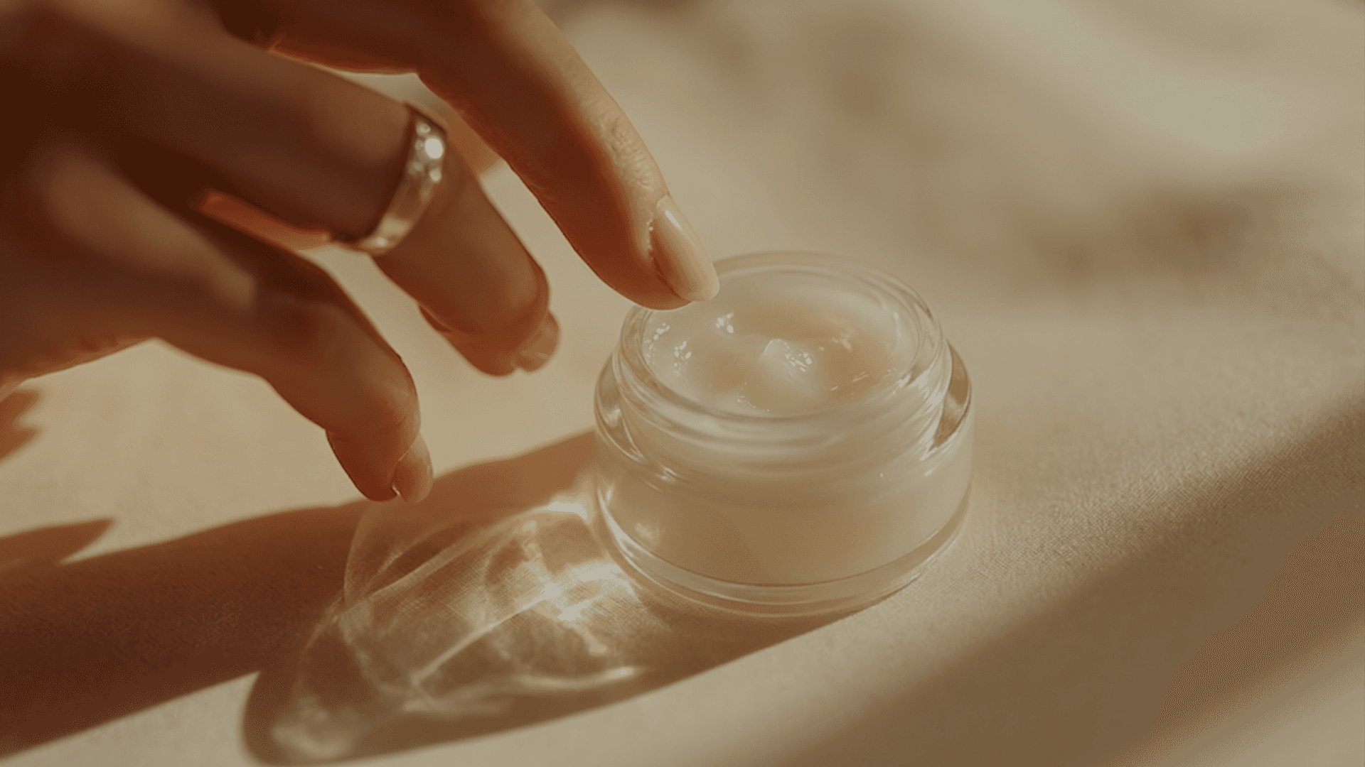 reaching for the vaseline in the jar