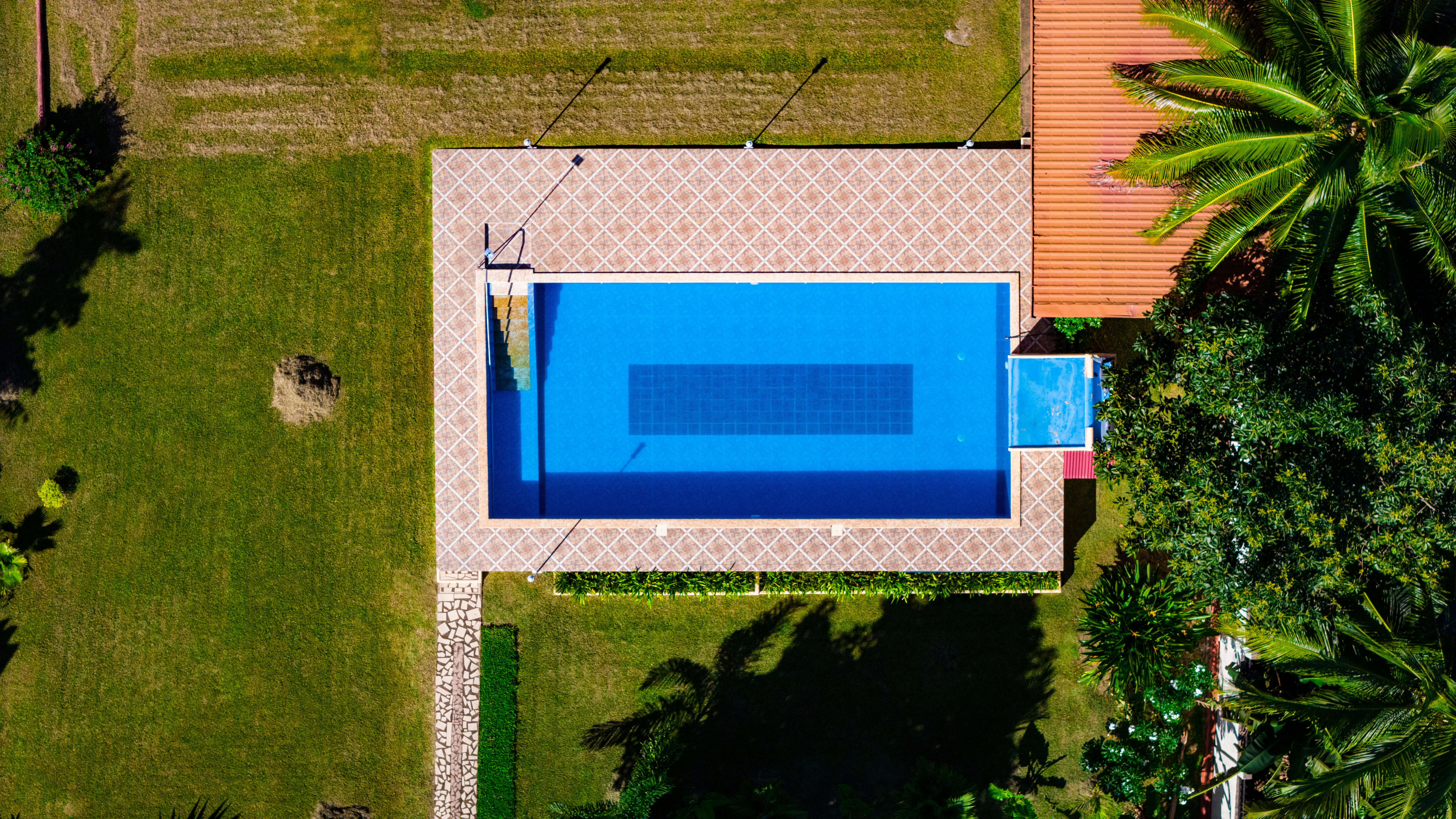 an aerial view of a house with a swimming pool