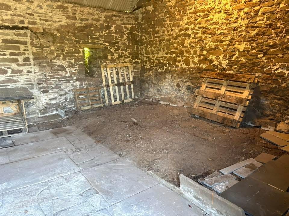 Outbuilding after completion of a waste clearance
