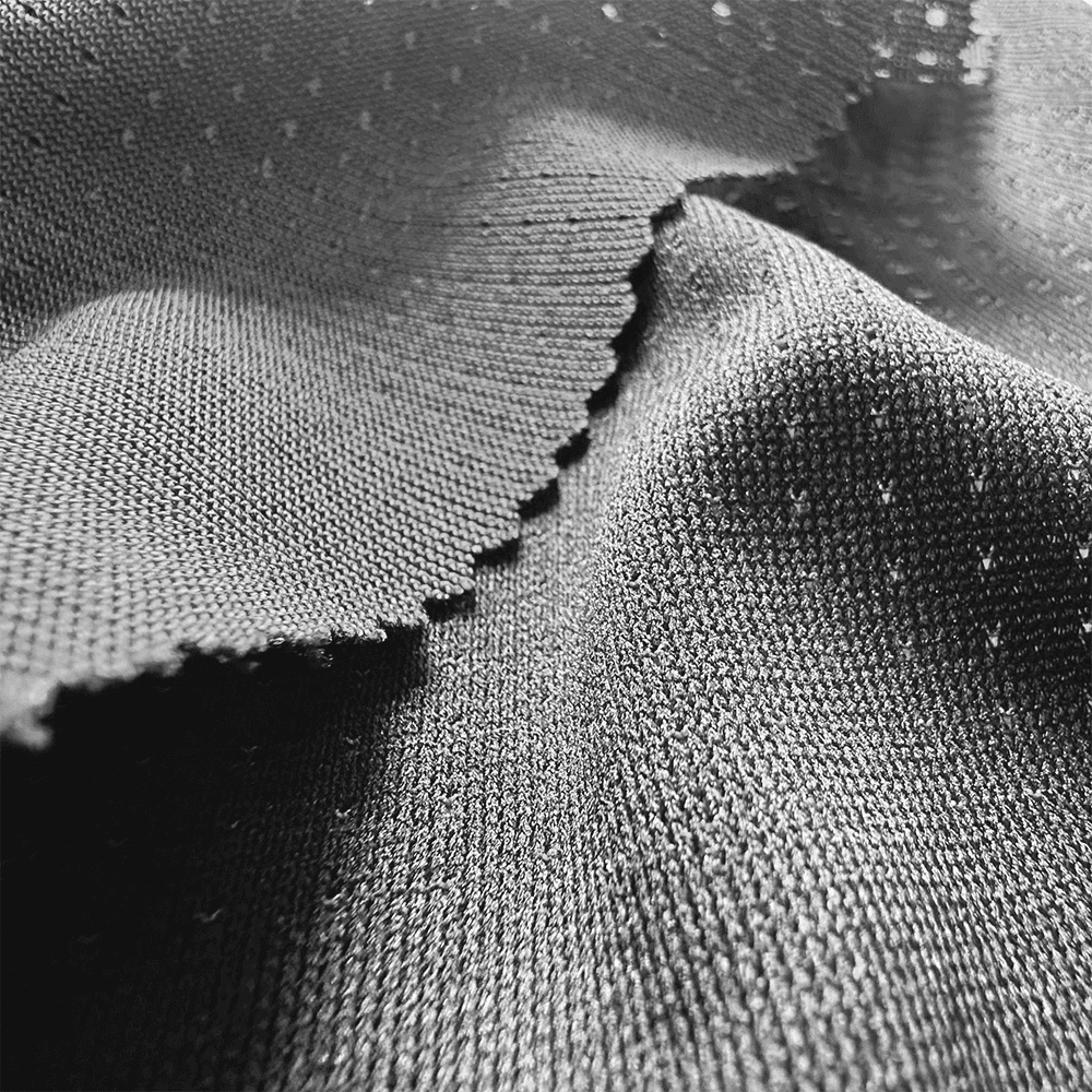 High-detail view of moisture-wicking mesh fabric for industrial manufacturing.