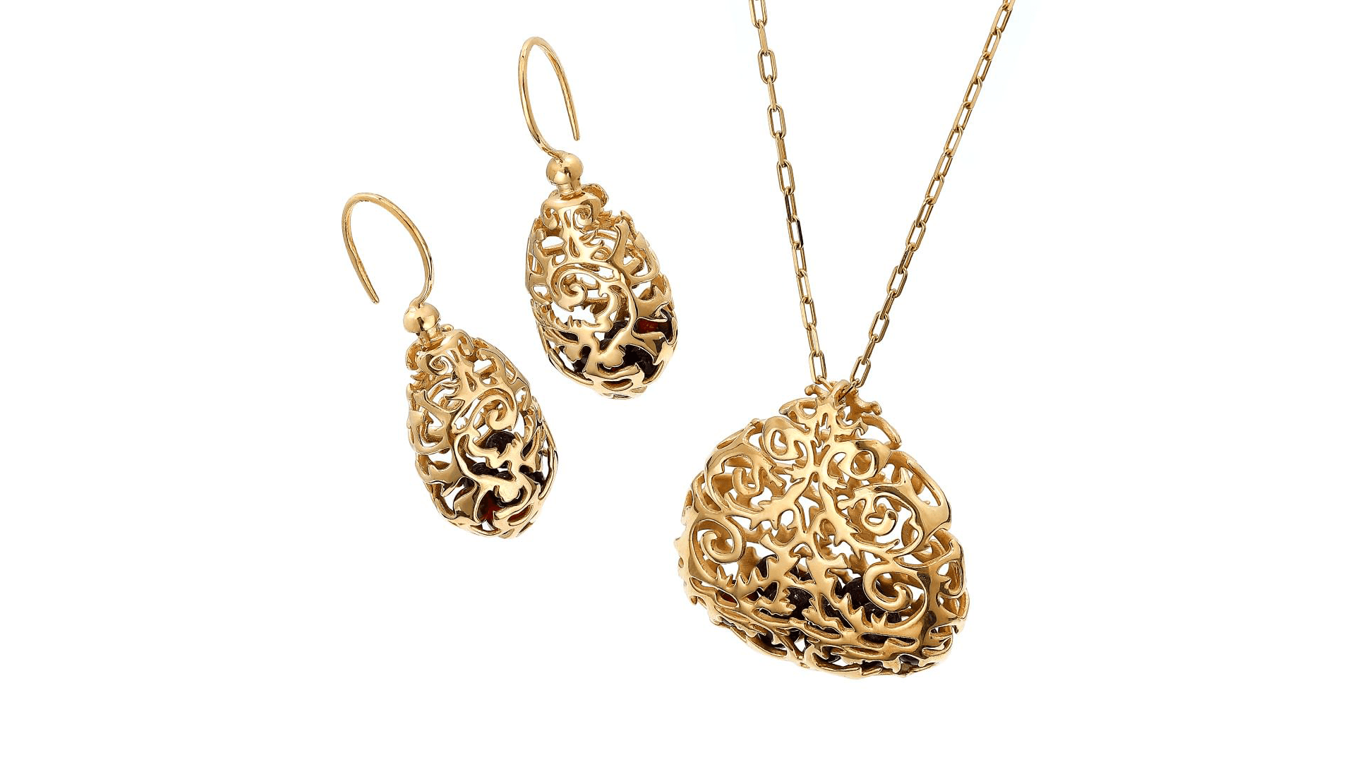 Gold filigree jewelry set featuring intricate drop earrings and a matching pendant necklace on a white background.