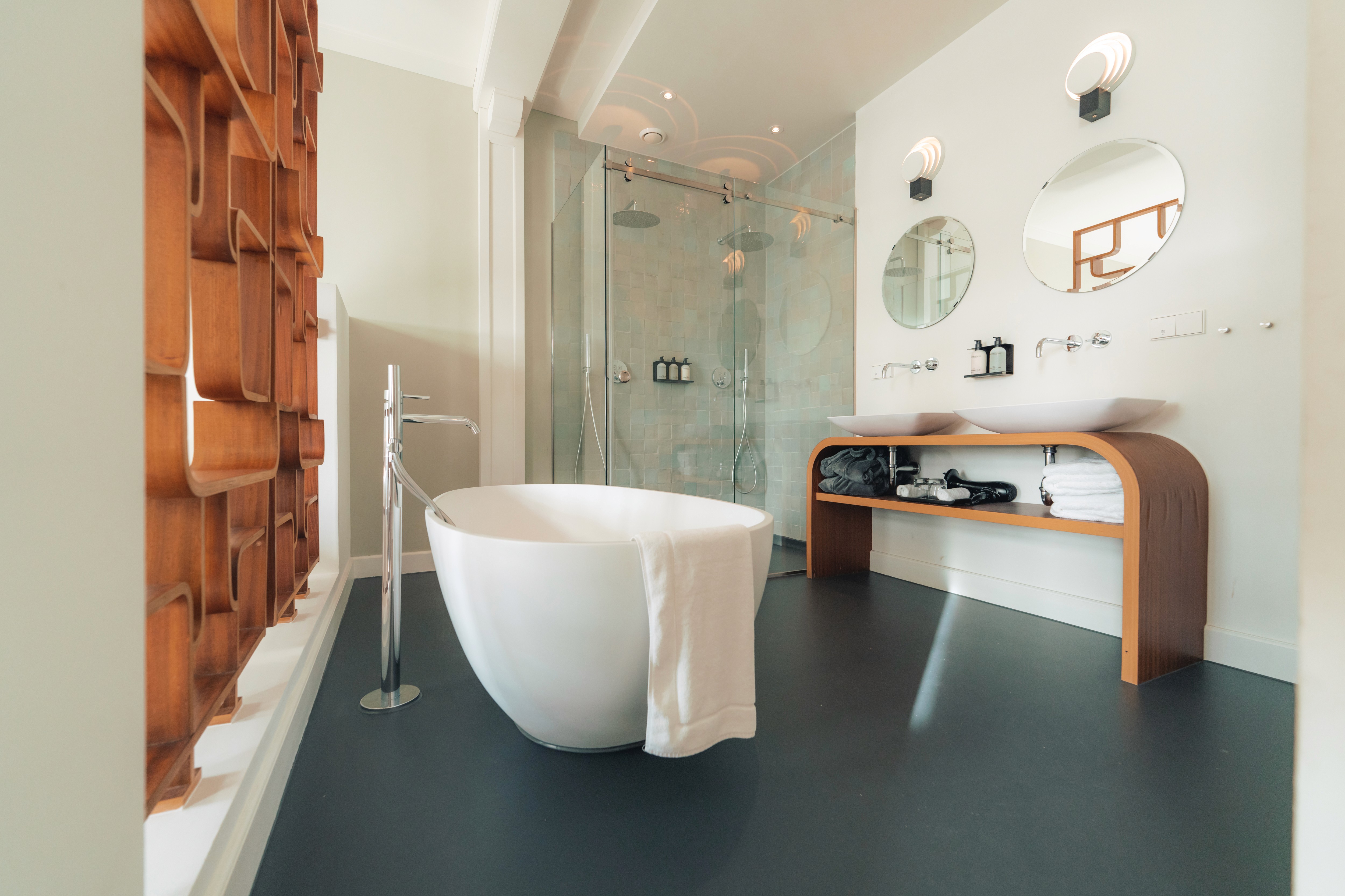 lounge room with large contemporary lamp, cozy sofa and blue toned painting of Venice