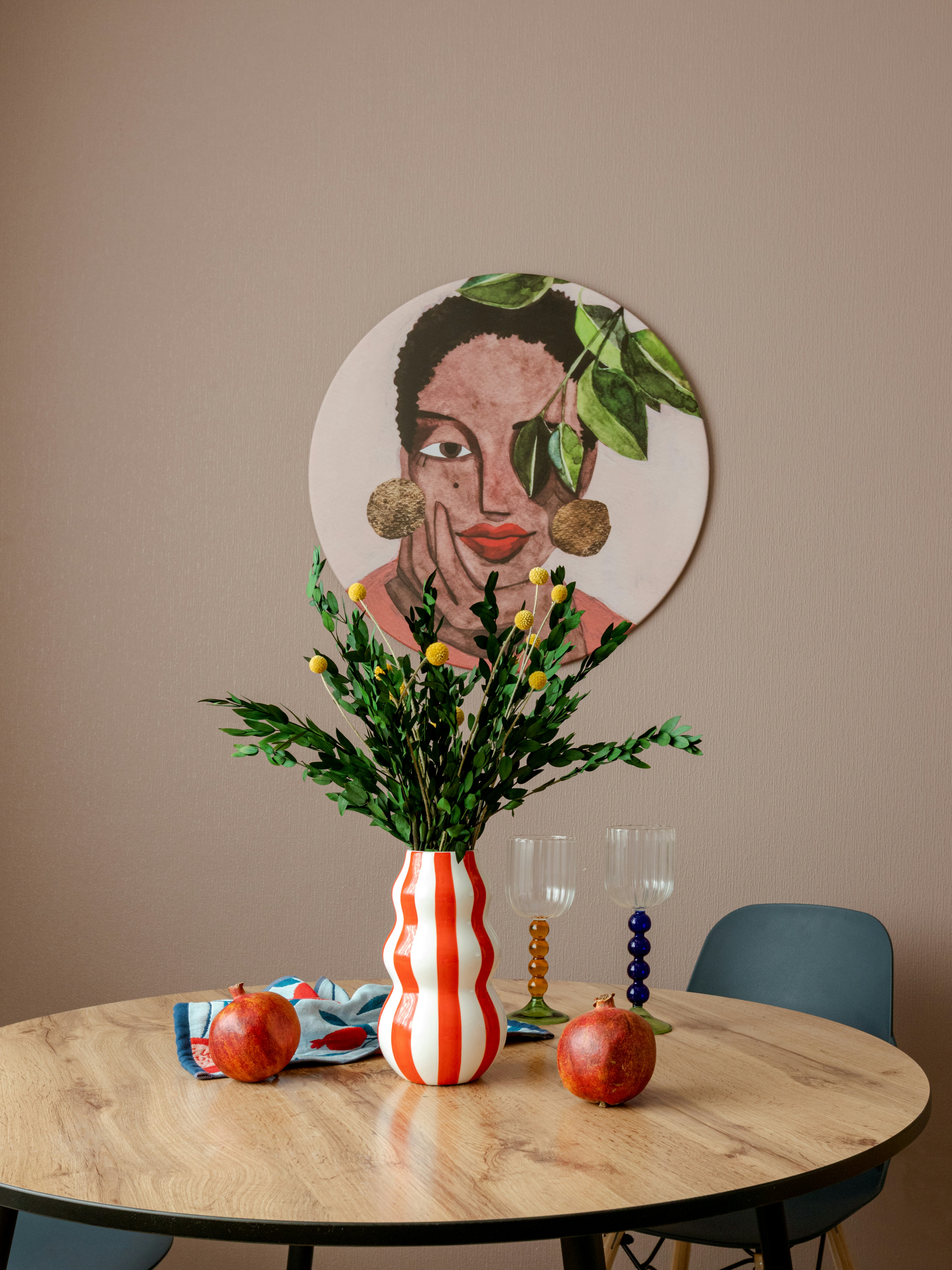 Round table with vase, apples, and artwork
