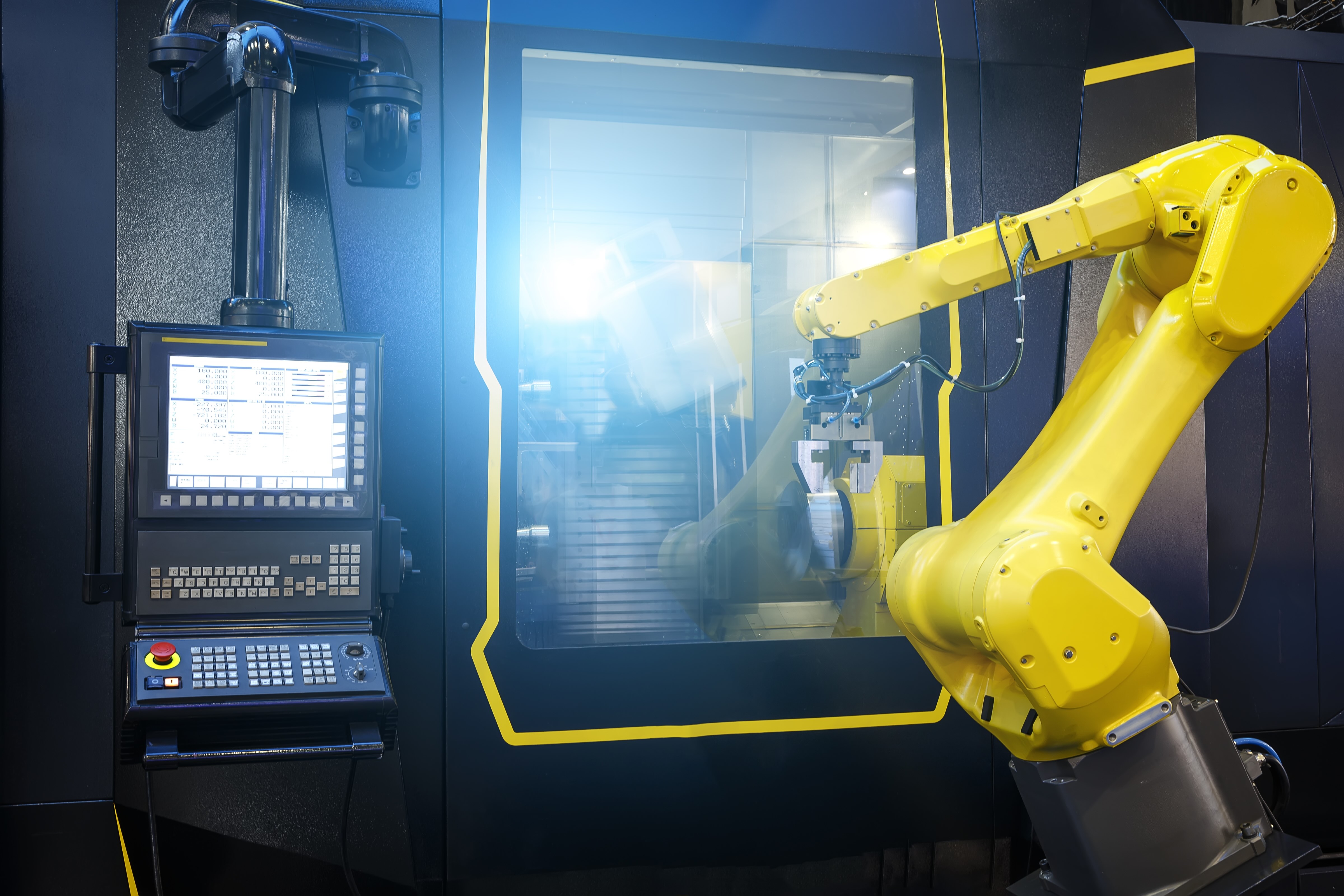 A robotic arm operates over a workspace, showcasing advanced automation technology in a modern industrial setting.