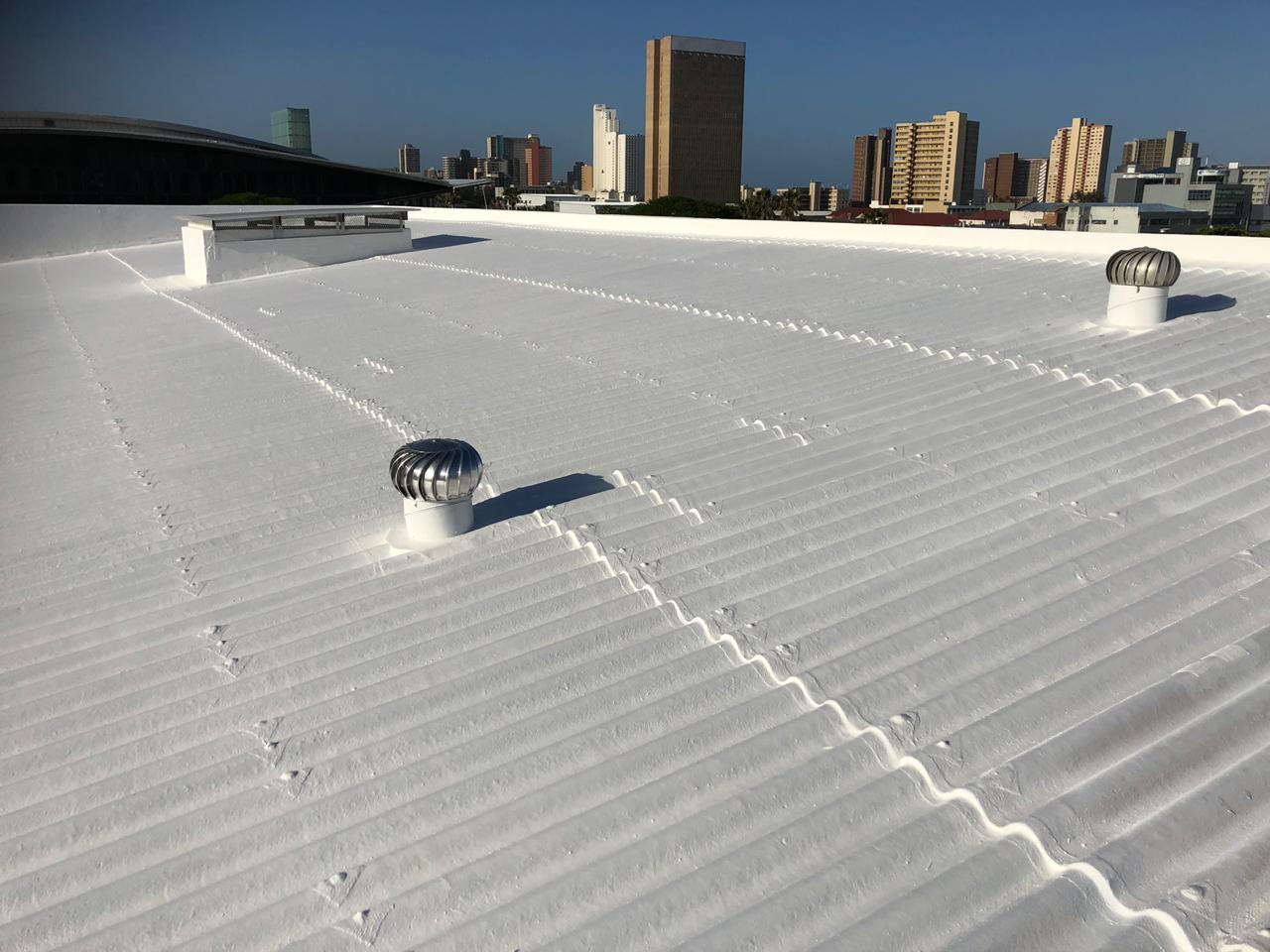 Industrial roof getting sprayed with waterproofiing rubber