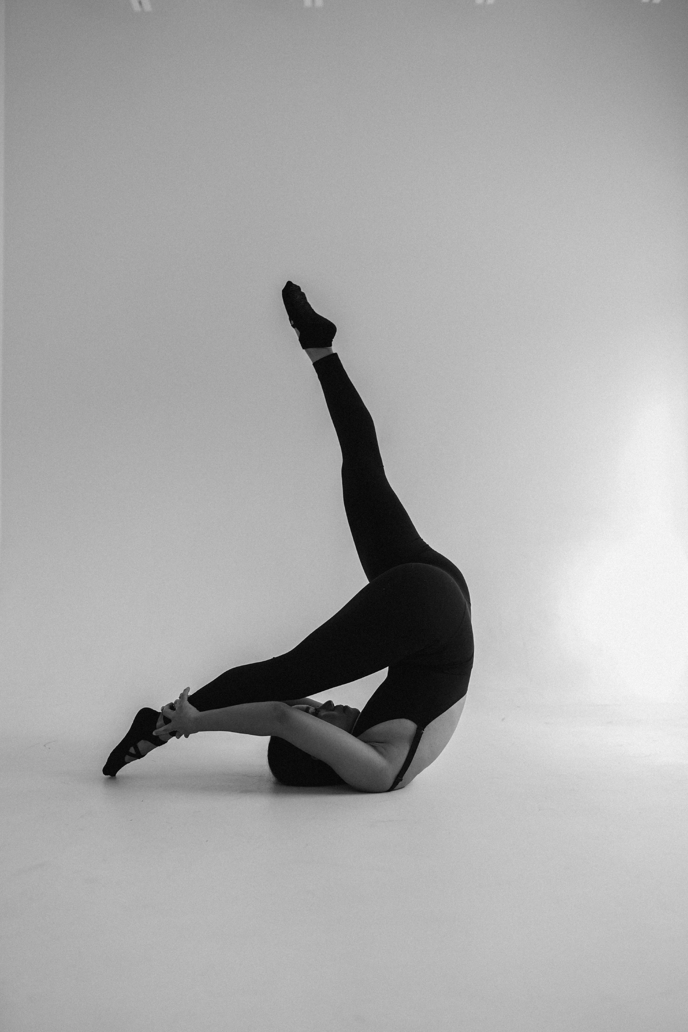 Dancer leaping in a white studio