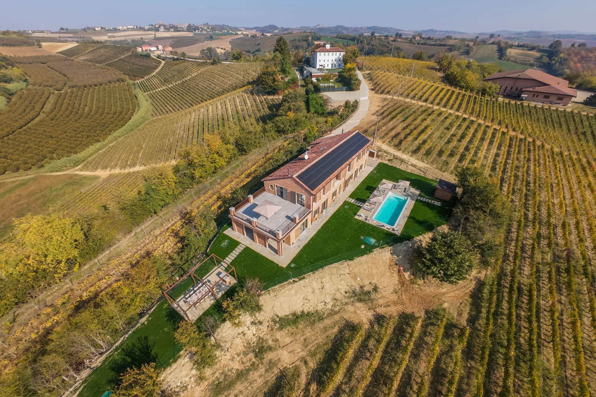 Villa surrounded by vineyards seen from above — Fubine Monferrato, Italy. Photography by Yunes Calore.