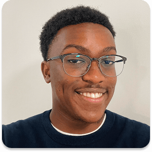 a man with a goatee smiles at the camera